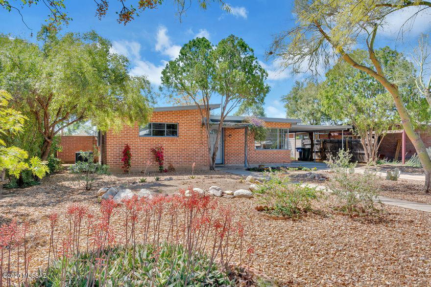 Classic wire-cut brick home north of University of Arizona, located just off of the Mountain bike path so many updates, including fresh paint inside and out, new (2019) A/C, new hot water heater (2020, gorgeous eat-in kitchen with 5 burner gas stove, refrigerator, dishwasher, granite counter top, marble back splash and under counter lighting. No carpeting. Large laundry room with utility tub and counter. Big walled backyard (plenty of room for pets, play, gardening, pool or home expansion) with large covered patio. Large storage room/workshop off carport. Sewer service to street replaced with last 5 years. Updated water/gas service from home to street (2019). Roof recently coated (2019) - 2 year warranty. EZ care front & back yards w/drip system.