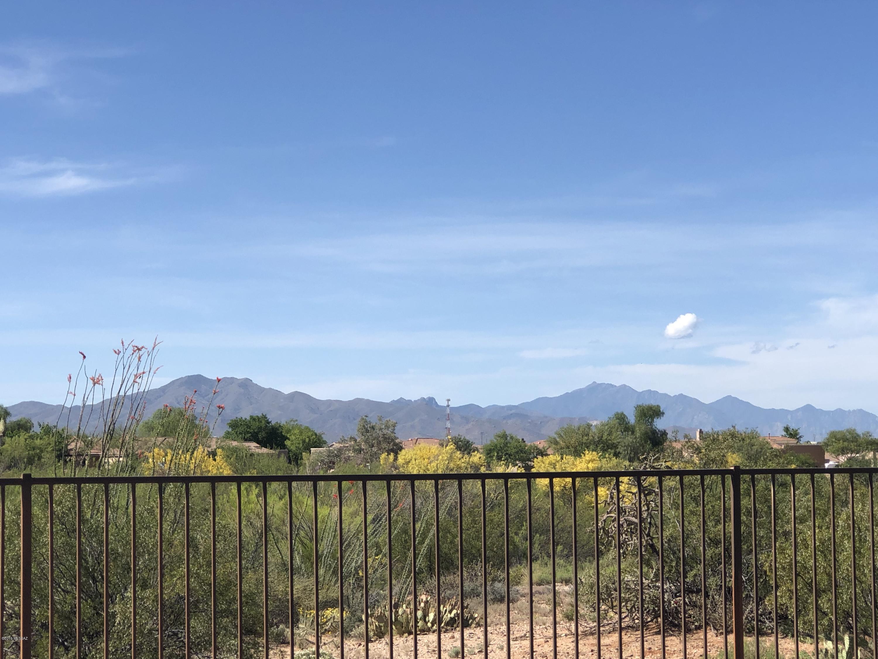 Looking for a home w/Privacy, Mountain, & Sunset views? Look no further.This beautiful 3 BR+den in the active adult community of Del Webb at Rancho del Lago has everything you need.This is one of the best privacy lots you will find w/numerous bird species & bunnies just outside your fence.Lots of upgrades in this newer Pulte home.Large kitchen w/granite counters, island & breakfast bar.Tiled backsplashes & stainless steel appliances make this a cooks dream kitchen.Great room has cozy fireplace & room for your big screen TV.Eating area off kitchen is large enough for big or small gatherings.Master walk in shower is tiled & very roomy.Dual sinks & granite tops.Built in speakers & upgraded lighting throughout. Walking distance to Lodge,Pools,Spa,Gym, & the rest of the wonderful facilities.
