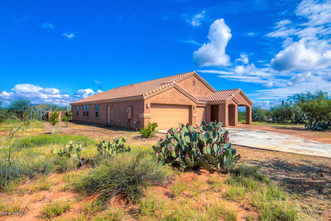 Beautiful well-kept Sahuarita home on a corner lot with lovely mountain and sunset views! This home has a 3 car garage. There are 4 bedrooms which all have ceiling fans. 2 bathrooms both containing dual sinks. Kitchen has lots of cabinets and counter space plus an island/breakfast bar! It also has a large walk in pantry and separate HUGE laundry room both off the kitchen- A must see to believe how big they are! The Home is pre-wired for security. Backyard has a covered patio, fruit trees and plenty of room to personalize and make your own!