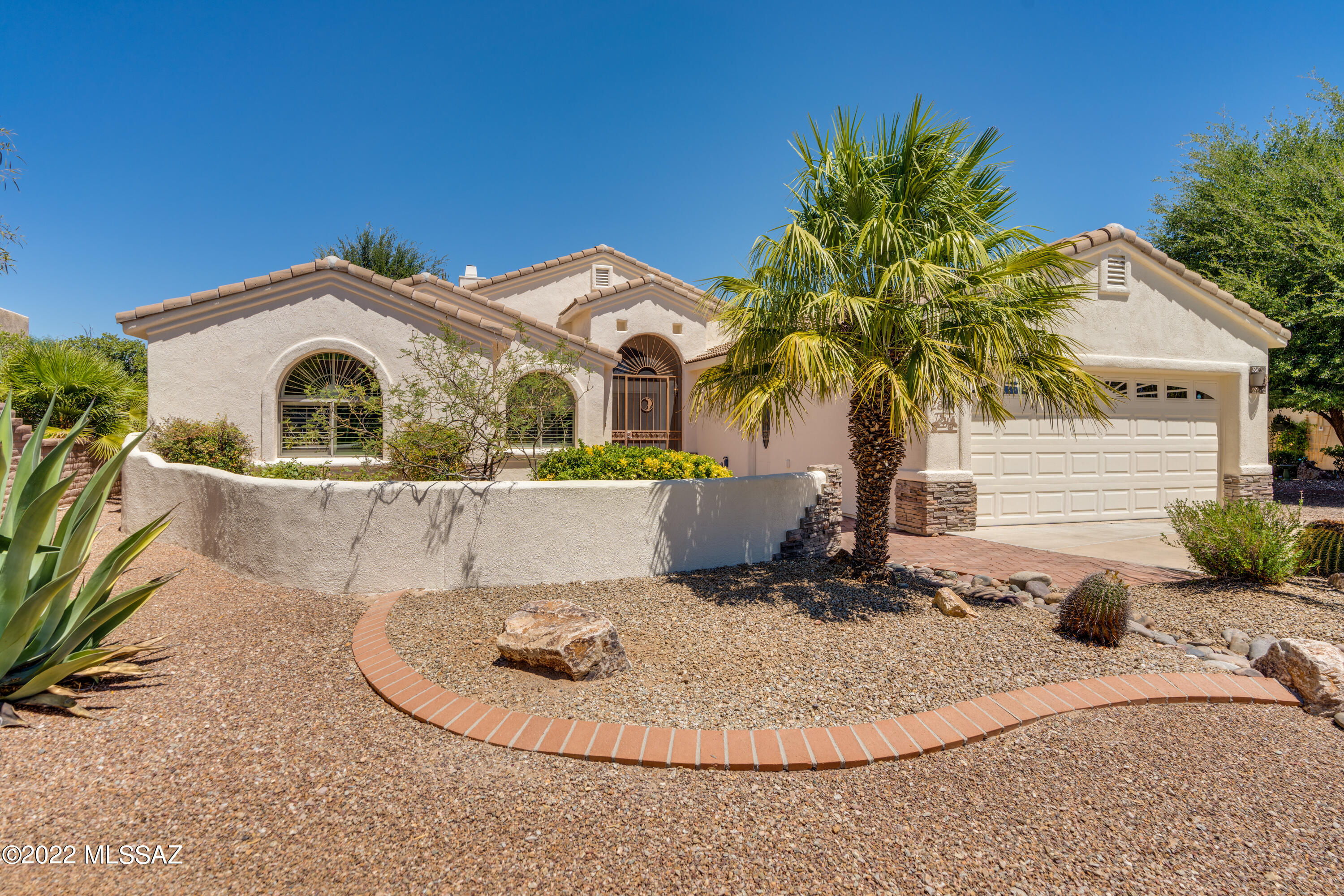 Prepare to be impressed with this beautiful home in The Links gated community. Expanded Rivera floor plan loaded with upgrades, including gorgeous tile floors, extended great room with a cozy stack stone fireplace and over 300 additional sq.ft. Kitchen w/ granite counters and all new GE stainless appliances (never used!). Formal dining space and breakfast nook. Owner's suite w/ bay window, remodeled bath with dual vanity, oversized walk-in tile shower, heated floors, closet organizers. Guest BR and remodeled guest bath w/ linen closet, walk-in tile shower; powder room off foyer. Front courtyard w/ mountain view. Super sized 4-car tandem garage w/ built-in storage, utility sink. Lush backyard w/ paver patio, nat. gas BBQ, mature trees, water feature. New roof 2017. Exterior repainted 2022.