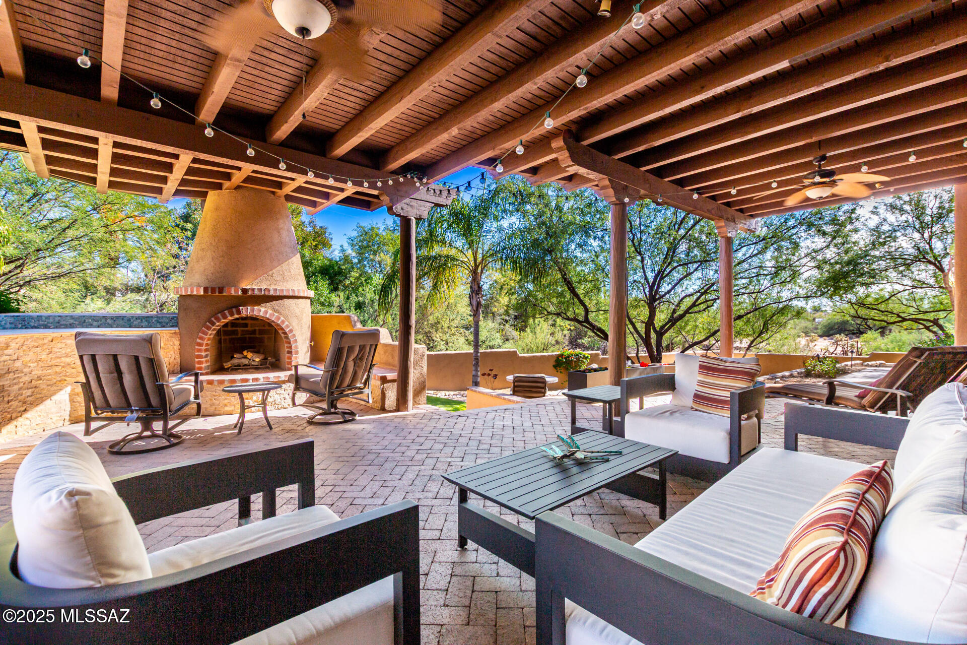 Casas Adobes Retreat Tucked away on a semi private drive, this custom home offers privacy with lush surroundings just minutes from shopping. Entertain outdoors on the expansive covered patio with fireplace, seating, and built in BBQ, or relax by the sparkling pool enhanced with a new water feature, tile, and Kool decking. Fresh interior/exterior paint, epoxy coated garage, dual new HVAC units (2024), and newer water heaters add peace of mind. Inside, the oversized 4th bedroom with dual closets is perfect for a home office or guest suite.