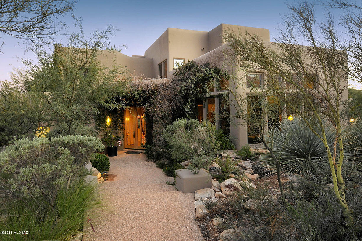 FABULOUS CUSTOM HOME IN GATED FINISTERRA ESTATES. CREATED BY ONE OF TUCSON'S MOST RESPECTED CUSTOM HOME BUILDERS & ARCHITECTURAL DESIGNERS; SOPHISTICATED, YET CASUAL, SPACIOUS, YET CHARMING..A HOME WITH A SOUL! A DRAMATIC FOYER PRESENTS THE FORMAL LIVING/DINING RMS W/POLISHED CONCRETE FLRS, BEAMS, SOFT ARCHES & NICHES. LOVELY MAIN FLOOR MASTER SUITE W/STUNNING MARBLE BATH & STUDIO LOFT. 4 ADDITIONAL BRS IN 2 SEPARATE UPSTAIRS QUARTERS OFFERING BOTH CHILDRENS & GUEST SUITES. UPDATED KITCHEN W/NEW CABINETS, MARBLE COUNTERTOPS, LG ISLAND, HICKORY FLRS, OPEN TO GREAT RM W/SOARING CEILINGS, BEAMS & FPL. INTIMATE OUTDOOR LIVING W/MULTIPLE COVERED & UNCOVERED PATIO AREAS, FOUNTAIN, POOL, SPA, BUILT-IN BBQ, AMAZING PANORAMIC MOUNTAIN & CITY VIEWS, 3 CAR GARAGE, 1+ACRE, LA IS RELATED TO SELLER