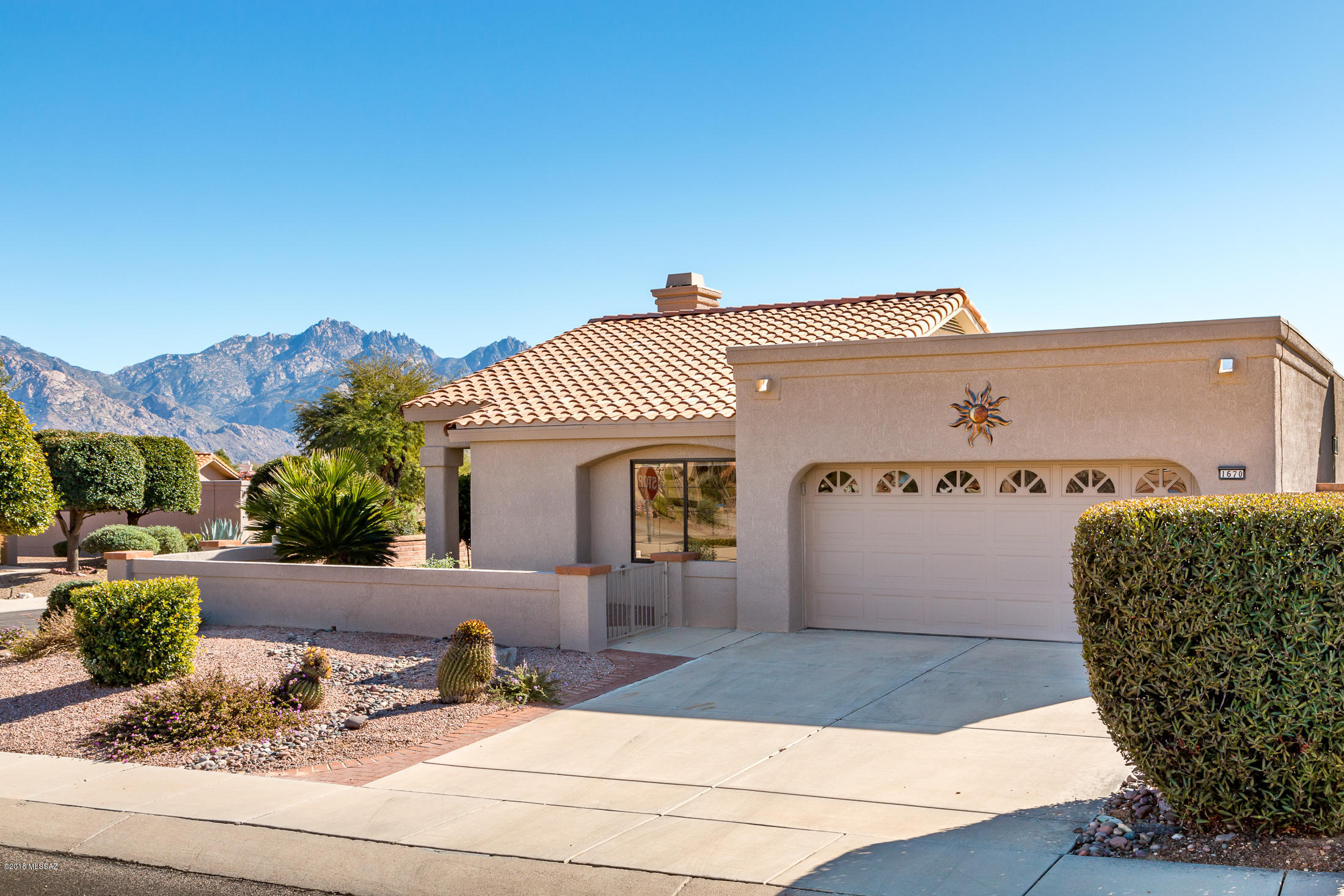 Gorgeous Mountain views from this Meridian Model. This home is a corner lot with an large private yard!
This split floor plan has large great room with corner fireplace and mounted 55 in TV. Beautiful views from the eat in kitchen, Murphy bed in
guest room, small office space. Front courtyard, completely fenced yard. recently painted inside and out. Come make this
one your own!