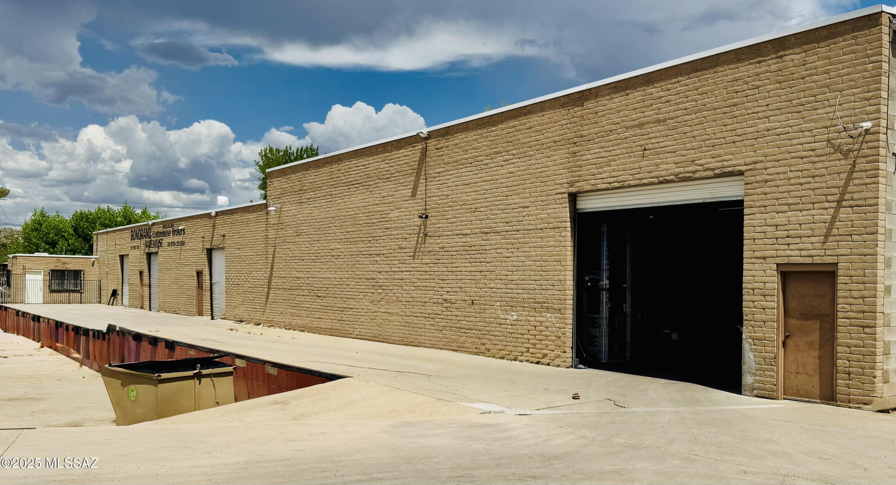 8976 sq ft warehouse with truck height loading dock on 1.04 acres off Grand Avenue in Nogales - block construction with four overhead doors and an office.  Close to the border - easy truck entrance/exit - Great opportunity.