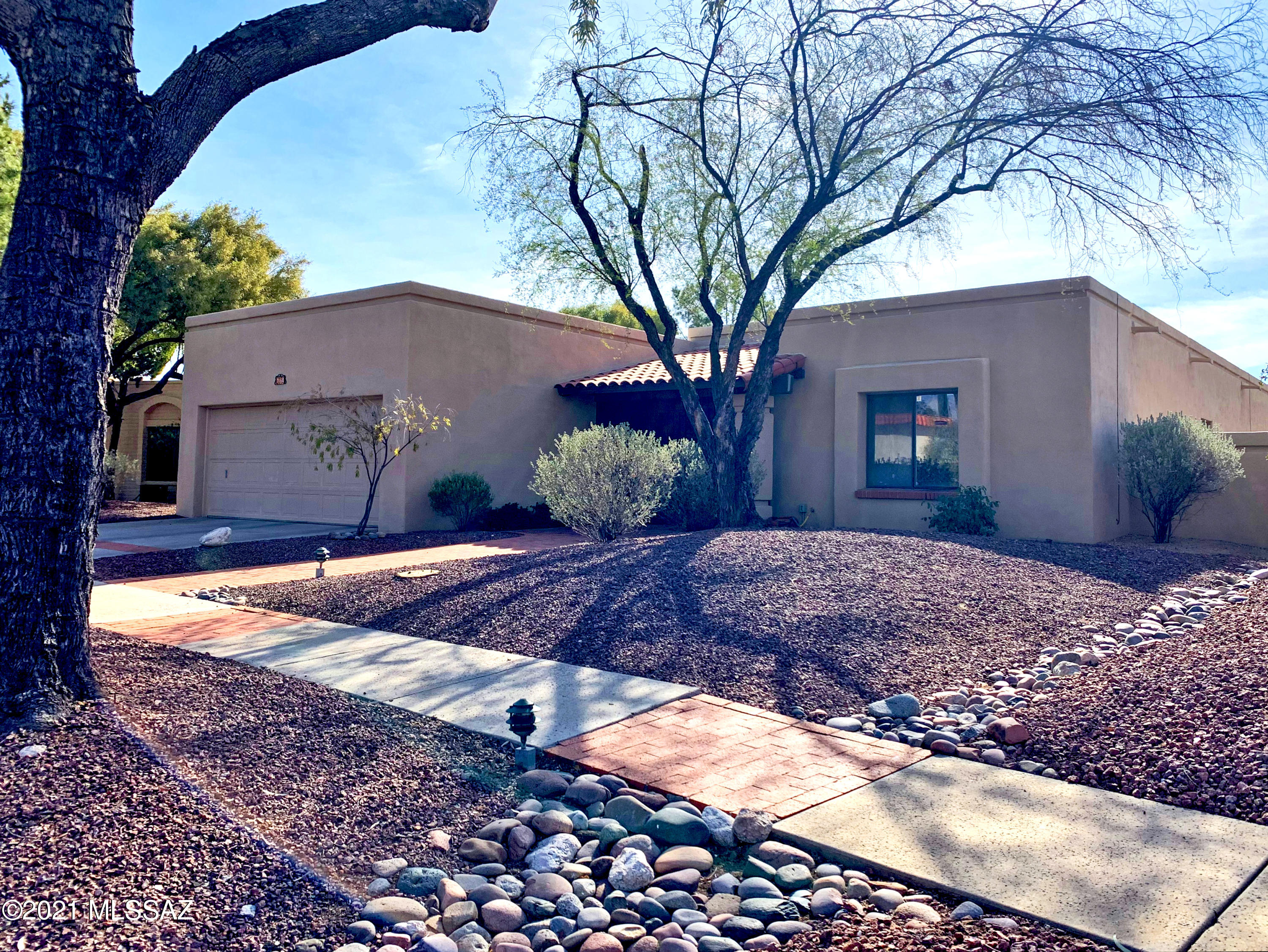 Wonderful home in desirable Sabino Vista. This is the home for entertaining friends and family! Spacious living room with high ceilings and wood-burning fireplace. Kitchen with breakfast nook has double oven and pass-thru to formal dining room. Access to back yard from dining room and master bedroom. Lots of windows for an abundance of natural light. Covered patio in back yard is perfect for a BBQ, morning coffee or watching the hummingbirds. Just a quick stroll to community pool & rec center; plenty of guest parking right across the street. Master bedroom has 2 walk-in closets,  fireplace and door to patio. Don't miss this one!
