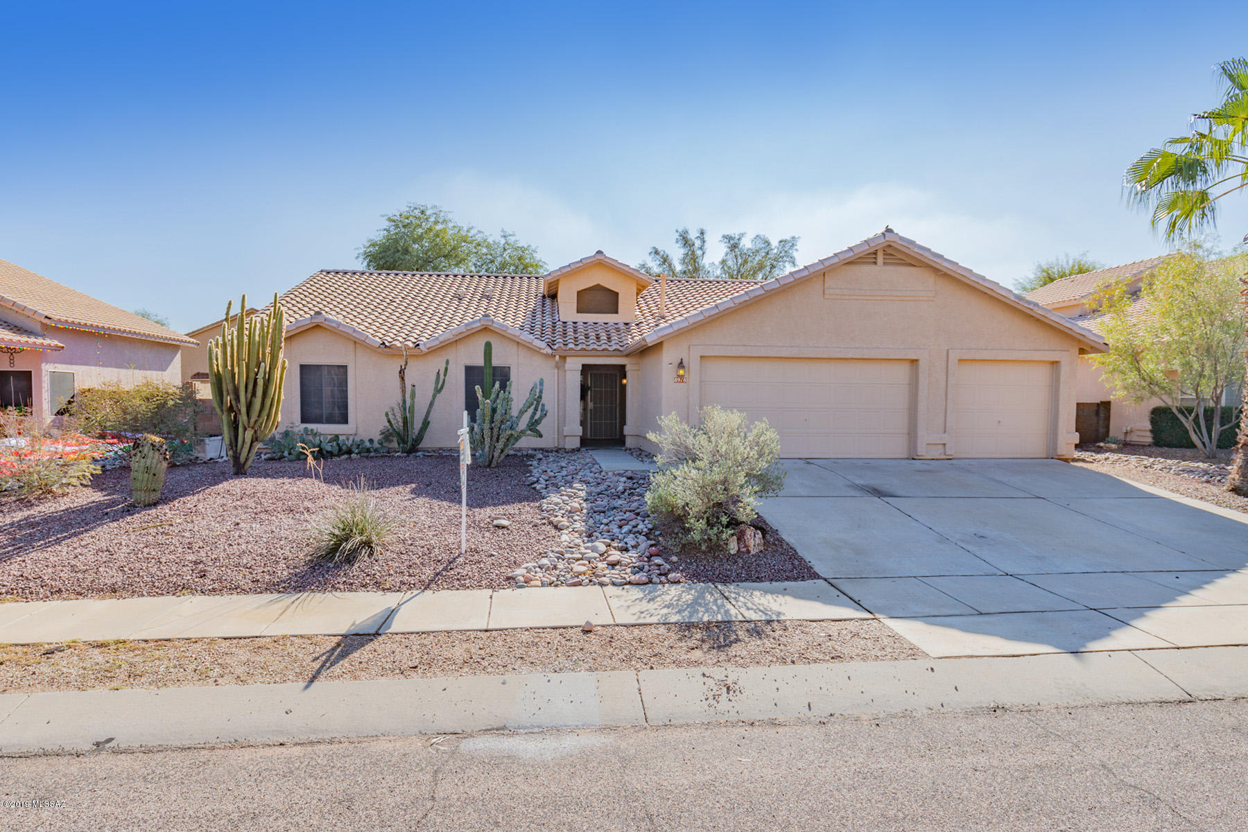 This lovely and spacious home is nestled on a quiet street with little traffic in the popular Continental Ranch neighborhood. It provides 4 spacious bedrooms and 2 bathrooms, fresh interior paint, new flooring in the bedrooms, over 2100sqft of living space and a three car garage.  A formal living room with a cozy fireplace greets as you enter into the home. Adjacent is the formal dinning area with elegant lighting that looks out to the rear yard with a large porch/patio that extends around the side of the home. The kitchen is open to family room perfect for entertaining while preparing a meal and busy evenings with the family. It has plenty of natural light and is appointed with a stainless steele refrigerator and dishwasher. All 3 bedrooms rooms provide plenty of elbow room and have new flooring. The master suite provides a spacious closet, new flooring and an archway leading to the master bathroom with his and hers sinks.  The neighborhood includes four nearby parks and a fabulously popular community swimming pool with splash pad. The location is excellent, with easy quick access to the Tucson Outlet Mall and downtown. This home has so much to offer. We look forward to sharing it with you.