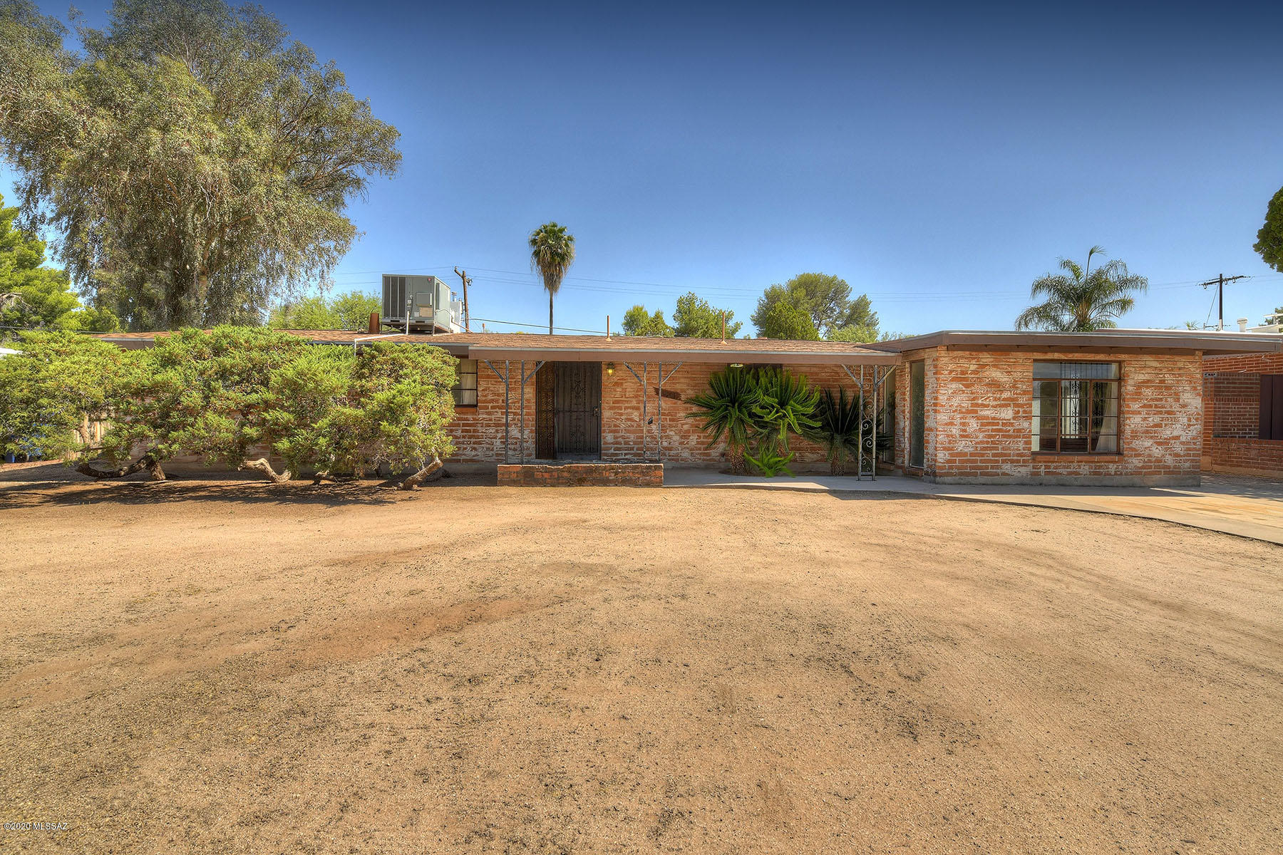 Mid Century Adobe in a fabulous central location. Almost 2000 square feet featuring a living room with cozy brick fireplace, large family room & kitchen with newer appliances & loads of cabinets. Master suite has remodeled bath including tiled shower. Guest bedrooms are spacious and share a generous full bath. Large walled in yard is a blank pallet ready to add all your outdoor activities. Newer roof & outdoor shed for extra storage.