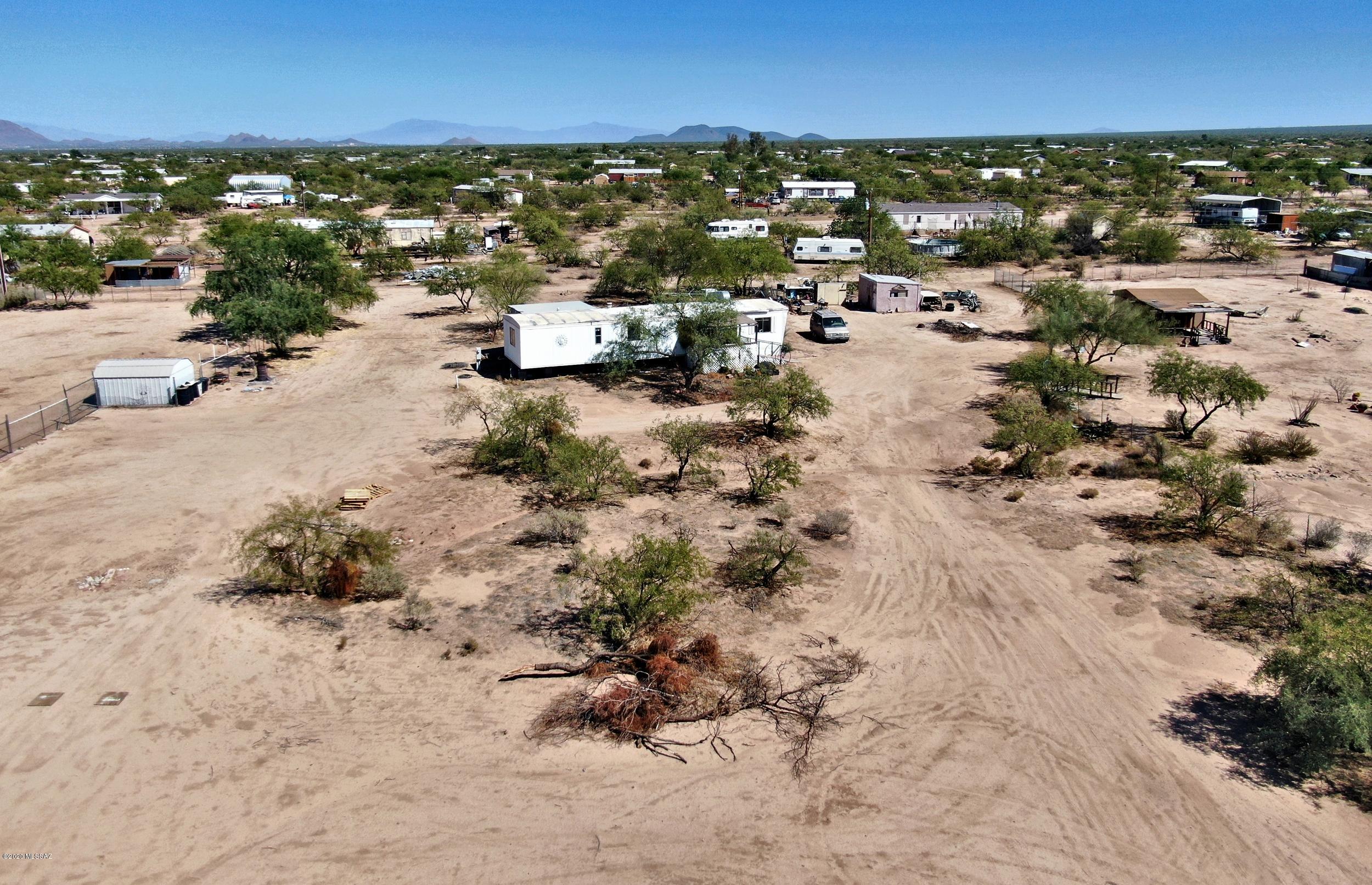 Range Priced: Seller will accept or counter offers w/in range price. Lots of options with this property. Lot has mobile home on it. The home is a fix-up and needs a total remodel. Buy for the lot and put a brand new manufactured home on this 1 acre lot. All utilities water and electric are on lot plus septic system. Enjoy peace & quiet being a little west of Tucson. From the lot enjoy the panoramic views of kit peak. Manufactured home next door to the north is for sale (see MLS # 22024511 )... Opportunity to own two adjacent lots and 2 acres. Owner will carry with 50% down. owner/agent
