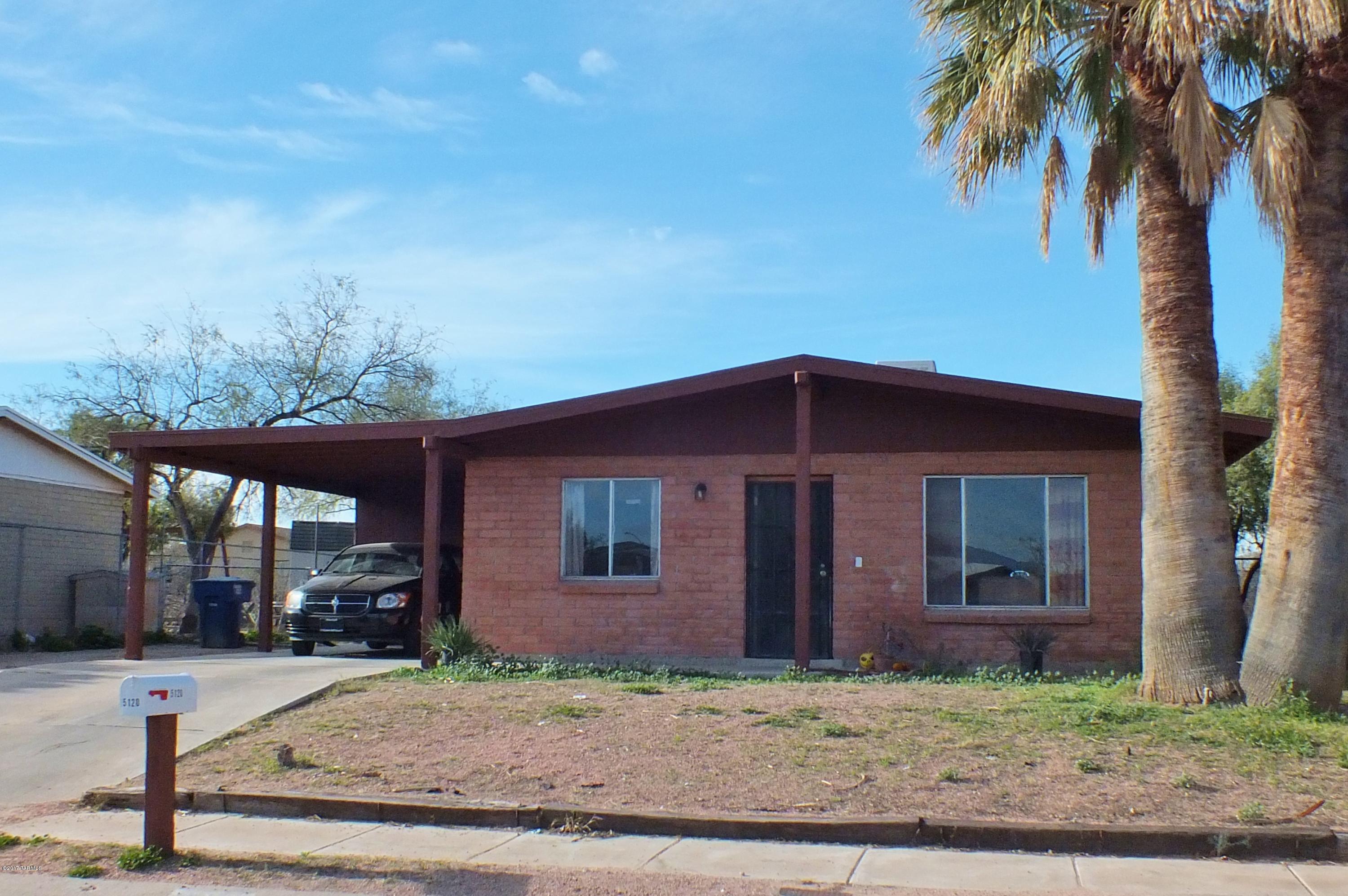 Cute and well cared-for home is ready for its new owner. Features include tile & carpet flooring, cozy and attractive kitchen with refrigerator to stay, ample living room with lots of light, security metal doors for safe ventilation and a large back yard backs to Rodeo Wash. Front yard has deep setback from street and a concrete driveway to carport. Quiet tucked-in neighborhood location.