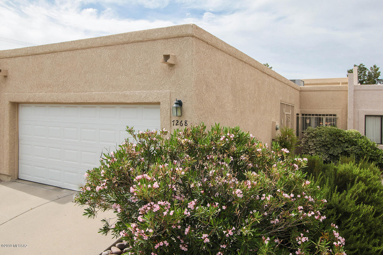 Lovely townhouse within walking distance from schools, shopping and restaurants.  Charming kitchen with a breakfast bar opens to living/dining area with high vaulted ceiling.  Modern master bath offers granite countertop, washbowl sink and large tiled shower.  Spacious second bedroom provides ample closet space. Enjoy privacy outside under the covered patio and enclosed backyard.  2-car garage has shelves for storage. Plantation shutters throughout covey as is. AC unit replaced in 2017, new roof in 2018, fresh exterior paint.