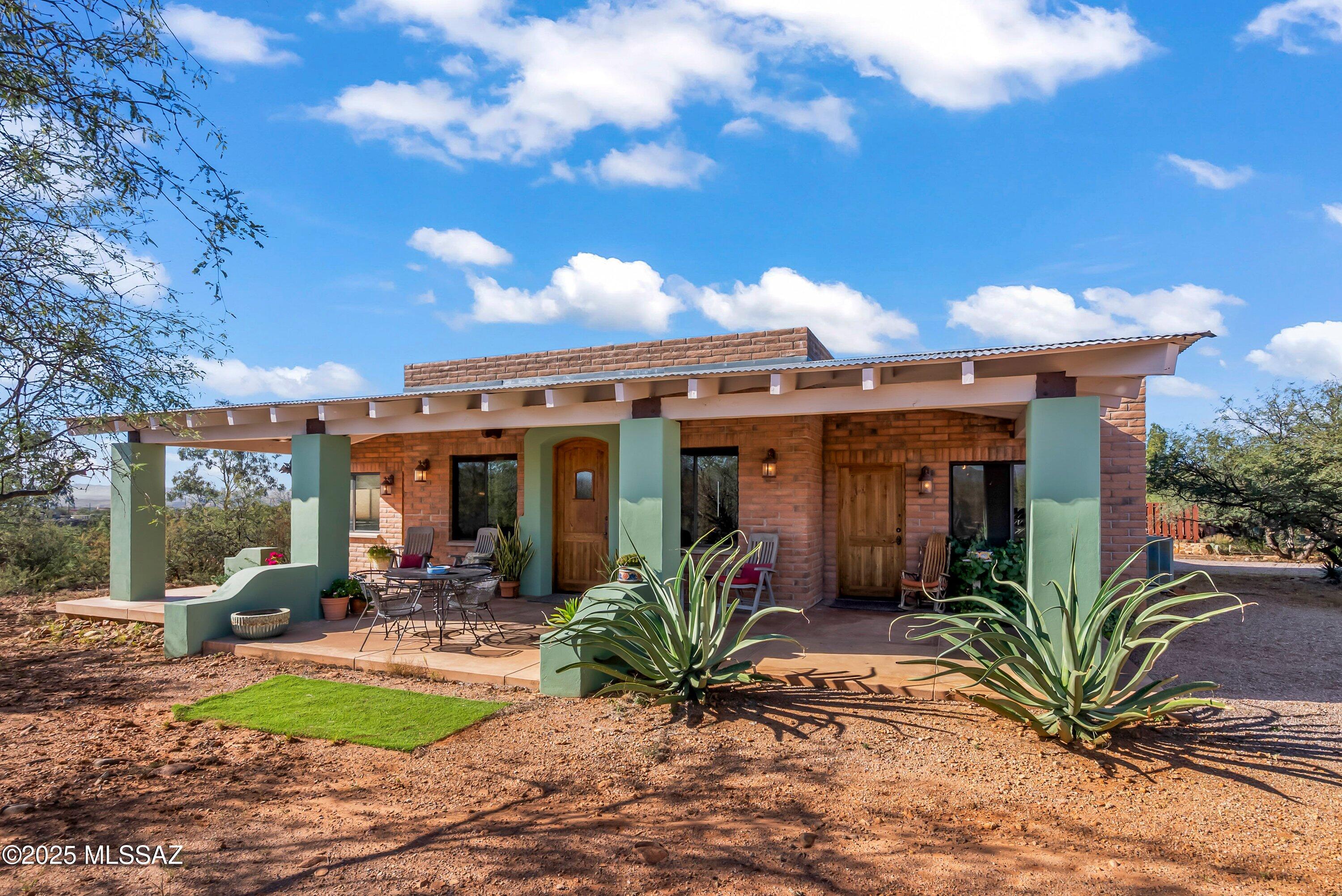 This equestrian property has everything you need to live comfortably!  A stunning home w/ 2 master suites, Great room with exposed wood & beam ceilings, a beautiful wood burning fireplace flanked by windows and 2 entry doors on each side.  The kitchen has a island w/ Spanish styled tiles, a wonderful butlers pantry w/ the main sink, dishwasher, refrigerator and plenty of cupboards.  Gorgeous Stone flooring and wood flooring in the bedrooms.  2 covered porches w/ 360* mountain views!  The equally stunning Casita has a beehive Fireplace,  Granite countertops, exposed wood ceilings, bedroom w/ access to the rear covered patio, tiled walk-in shower & laundry closet.
A ''cowboy'' bar under roof, outside of the tack room, has covered parking for 2 or 3 more vehicles or trailers.  detached 2 c