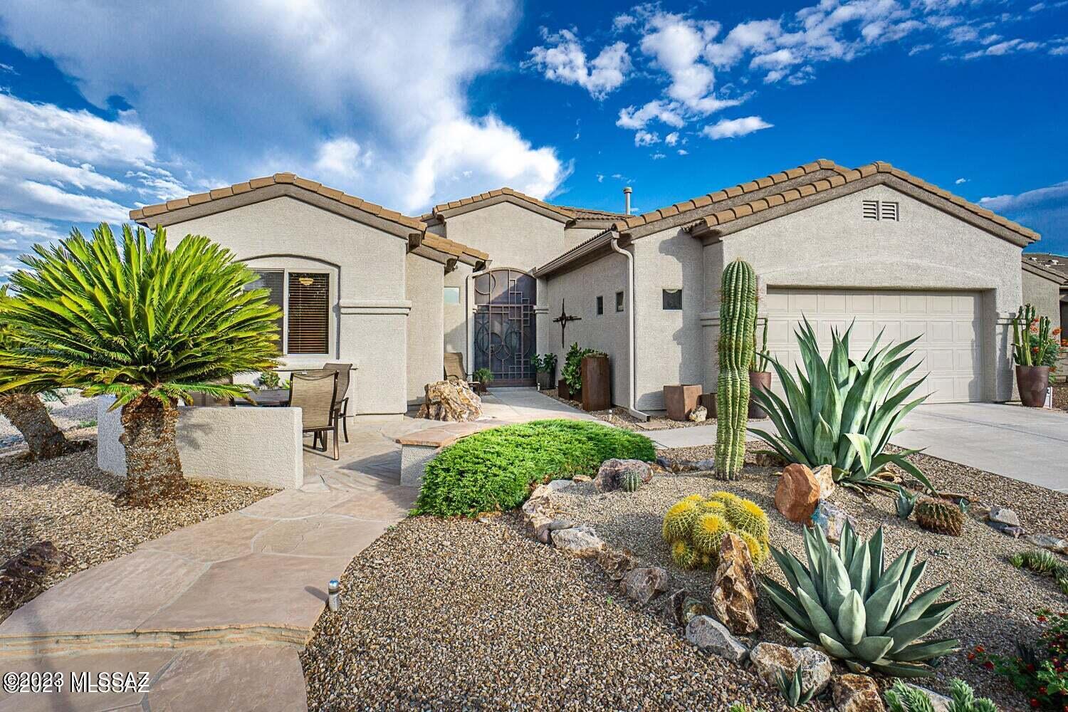 So many great updates throughout! Walk up to a secured screened porch then to a majestic set of custom steel doors. Enter the home to see thru to the AZ room (with remote controlled shades) & then to the Santa Rita mtns through Andersen Windows and if that doesn't knock your socks off, you'll have the best view standing at your kitchen sink as you are surrounded by cherry cabinets, granite countertops, & stainless appliances. Additionally, there is an office/den as well as a craft room with custom built-in floor to ceiling cabinets plus a wet bar! The 5-star spa-like bathrooms were upgraded by Gary Cooper & have smart mirrors, rain shower heads, executive height quartz counters with tons of storage. Main bath shower has beautiful amber tinted glass. This house is a must see! Agent/Owner
