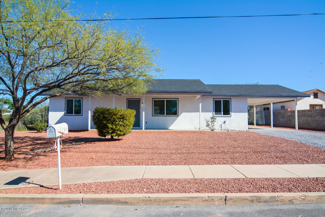 Beautifully remodeled Ranch style home. Located in a convenient South Tucson location. Rich wood laminate flooring. New modern kitchen with granite counter tops and stainless steel appliances. New custom interior and exterior paint. New upgraded carpet in bedrooms. Completely remodeled modern bathrooms. Nice large back yard. One car carport. Dual pane windows. Upgraded door hardware and light fixtures. Professionally landscaped front yard. This home shows beautifully. Vacant North lot can also be purchased.