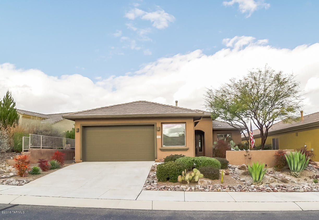 A beautiful Bonita model floor plan that is sitting high on a hill overlooking the Canoa Ranch Golf Course where you can also appreciate views of the Tucson Mountains miles away to the north. Beautiful river rock and indigenous shrubbery decorate the front landscaping which includes a Flagstone front courtyard that makes a wonderful place for coffee and conversation with neighborhood friends. When you walk into the great room you will notice the beautiful diagonal ceramic floor tile, wide open floor plan and arched gateway passages. A cook’s delight kitchen with an abundance of cabinets and countertops, double door pantry plus a convenient breakfast nook. The open area adjacent to the great room can be used for either a formal dining room or an office/den area. Your master suite has walk-out patio access and the bath features his and hers vanities and built-in makeup station. Built-in workbench in this oversized 2.5 car garage. Relax on your extended covered patio and enjoy expansive views in every direction!