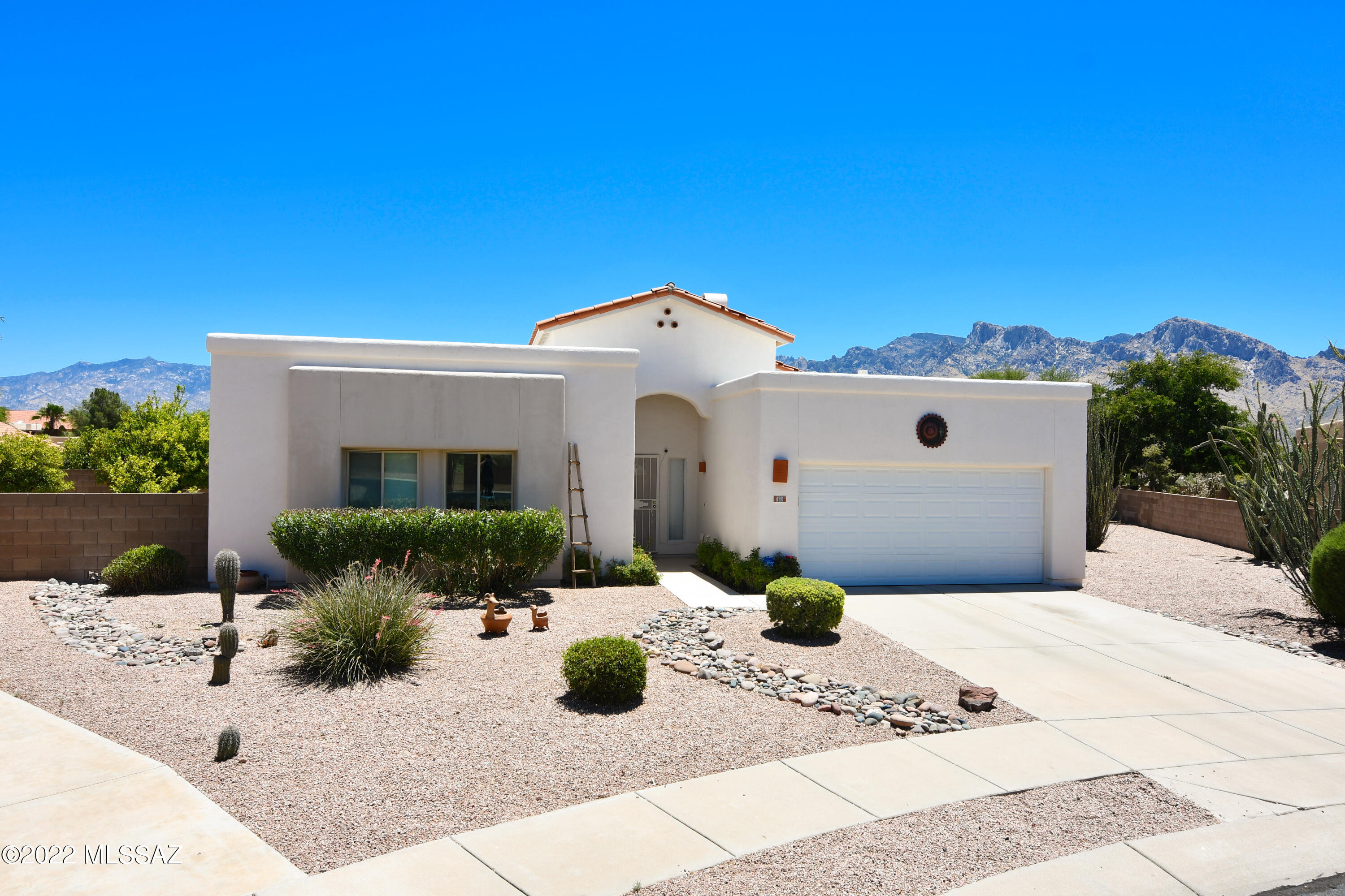 Wonderful Monterra Hills home with breathtaking mountain views from the moment you walk through the front door.  Bright airy home with 3 bed/2 bath,  vaulted ceilings, kitchen with stainless appliances, gas range, and solid surface countertops, Sunny breakfast nook & Great room with warm and inviting fireplace with built in niches, laminate wood flooring,  Primary Suite with Walk-in Closet & recently remodeled en-suite bath with floating vanity and oversized walk in shower.   Situated on a quiet cul-de-sac lot in the heart of Oro Valley with giant resort style backyard, sparkling pool/spa, flagstone covered patio, mature citrus trees and Pusch Ridge views.  Extra storage in laundry room and built in storage in garage.  Move-in ready!