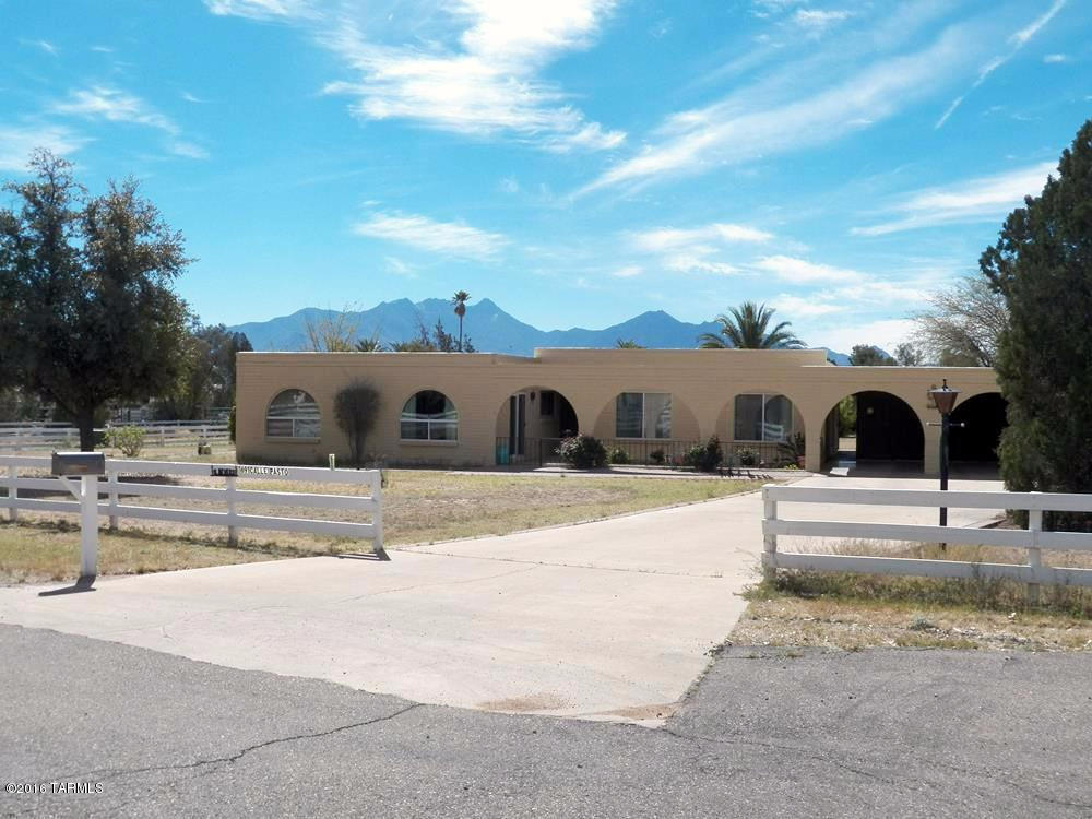 Rare opportunity to own a horse property in the midst of Green Valley. 3.56 acres fenced with 2 large pastures. Horse facilities include 4 stall barn, pipe corral turn-outs, tackroom, feed storage, water and electric at the stalls. A section of the barn has a large workshop, half bath, single garage and double carport. Known as the Ranchettes, this non-age restricted HOA maintains an outdoor arena for its riders. The 4BR 2BA territorial home features a large kitchen open to the family room and beehive fireplace. Newer dual pane windows and doors lead to a full length covered wrap-around patio with views of a lovely backyard, perhaps your horses grazing as sun rises over the Santa Rita Mtns. A rose garden greets visitors as they approach the front patio. Over 3 acres provides plenty of space for a pool, playground equipment, RV parking, horse trailer or perhaps building a casita. Freedom to expand at your leisure.