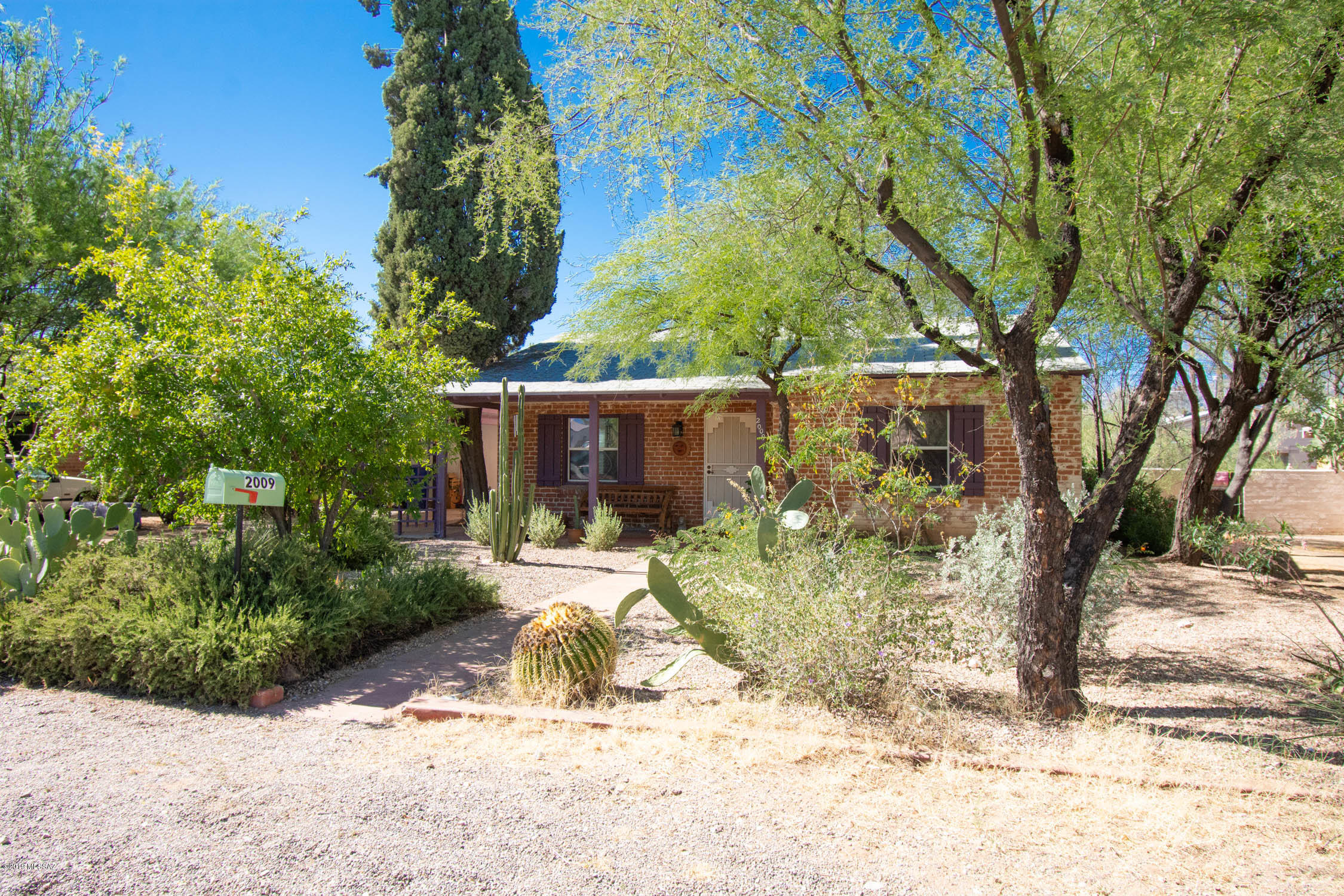 Classic Central Tucson Home in Woodland Park!  VERY quiet!  Polished concrete floors, saltillo tile kitchen, HUGE room in back that can be used as a Master Suite with a full bath or a 2nd living area.  DUAL COOLING!!!  Large storage room/workshop off carport.  Beautiful desert landscape w/gravel in front and rear of home as well as drip irrigation.  Walled rear yard with sliding gate entry.  Walking distance to restaurants, groceries, shopping, hardware, etc as well as less than half a mile to Conner Park!  1.5 miles to the University of Arizona and less than a mile to Banner hospital.  You can't get more central than this!!! Schedule a viewing as this one will go quickly!