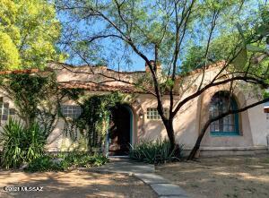 Welcome home to Jefferson Park Historic Neighborhood with all the benefits of historic designation. Coved Ceilings, combination of solid oak and saltillo floors throughout. Bi-level entry way and living room with lovely fireplace, track lighting and display shelves. Kitchen has oak cabinets, tile counters, open on two sides, perfect for entertaining with breakfast bar, small dining area in between. 3rd small bedroom could be a great home office. Unique in Tucson this home has a small basement perfect for storage or maybe a hobby room? Outside fully fenced yard, studio/laundry converted from an old one car garage. A Lovely university home with southwest ambiance, quality, convenience to campbell corridor, mountain avenue, multi use paths, downtown, UA, more!