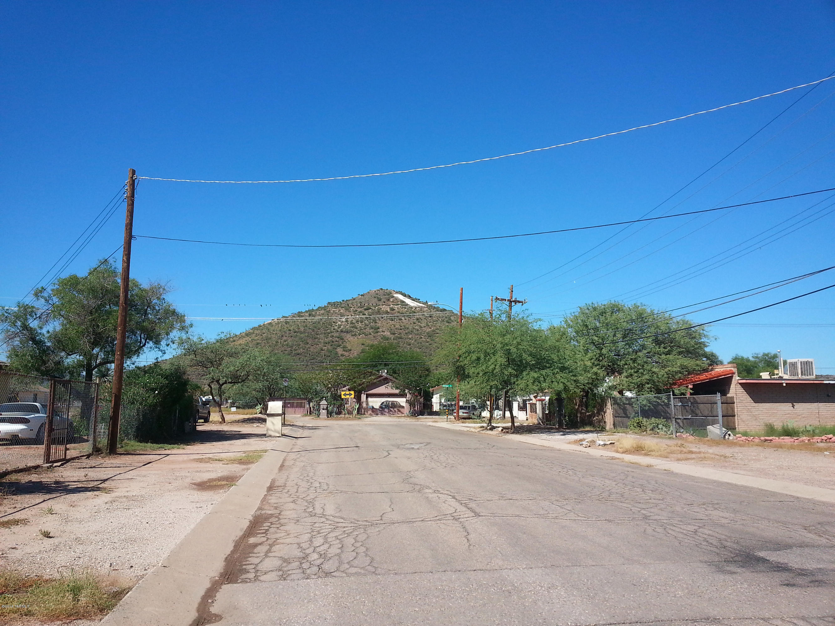 About 1/2 a mile south of the new Regional Headquarters for Catepillar. Great site for a Barrio project in the shadows of ''A Mountain''. Very close to downtown and all its amenities and employment. Rare Amazing Infill opportunity.  A proposed siteplan shows a possibility of developing 10 lots on the property.  Owner is selling 5 parcels all together totalling 1.3 acres. Great for entry level or low income housing.  Or build for rental units.  Flat and ready to build.  Great R-2 City zoning.  Beautiful Park ''Verdugo Park''  down the street on the Santa Cruz River walk path with lots of amenities.      Also very close to Pima Community College, St. Mary's hospital, and Star Pass.  This wont last long at this price.  Ask broker for a detailed Information Package.  Submit all offer