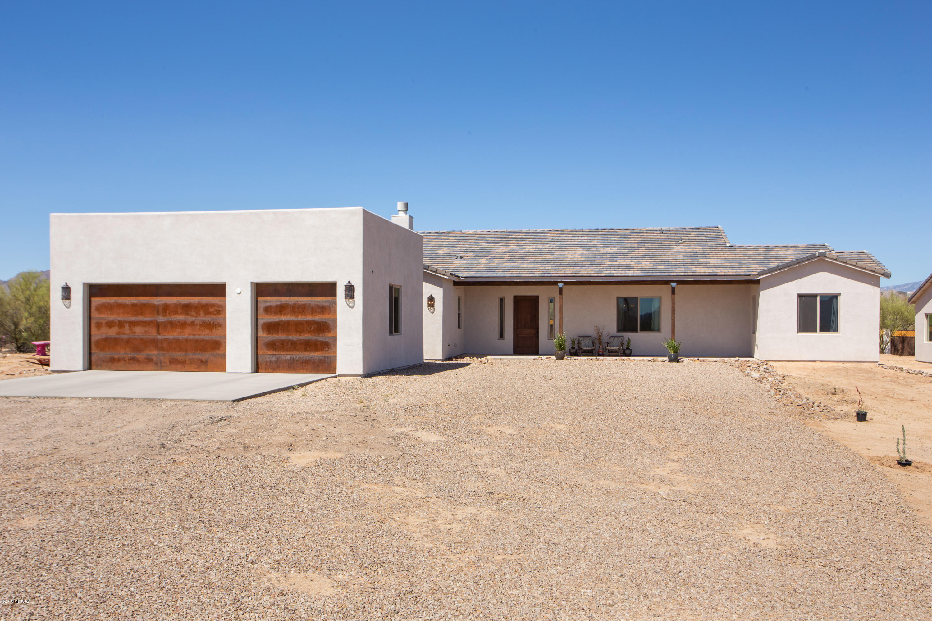 Seller will accept or counter offers between $645,000-$660,000. Property was just appraised and is priced below appraised value!! Are you looking for a custom home with land? Well look no further; with this property you will get two beautiful custom built homes on a 3.3 acre fenced lot with private well (2- Shares). Boasting lifetime warranty Millgard windows, Brazilian granite countertops throughout, custom knotty walnut cabinets, 8ft knotty alder doors, travertine tile, custom light fixtures, custom Brazilian slate fireplace, tank less commercial water heater that provides instant hot water, and 3 car garage. The main home features an automation rack in the media room for complete access to both homes and media room is pre-wired for dolby atmos home theater system and features 5.1 surround in living room. Additionally, wet-bar plumbing was added for the ultimate entertainment room which also has ceiling speakers (could be 4th bedroom). Step next door to the guest house which has 1345 sq. ft. with 2 bedrooms and 2 bathrooms and a 2 car garage with the same custom features as the main house. These custom homes were designed and built by Madan Builders whom primarily build estate homes in Stone Canyon. This home is close to Tucson Premium Outlet Mall, new hotels, hospitals, and is a 3 minute drive to interstate 10. There are too many features to list, you have to see it to believe it!