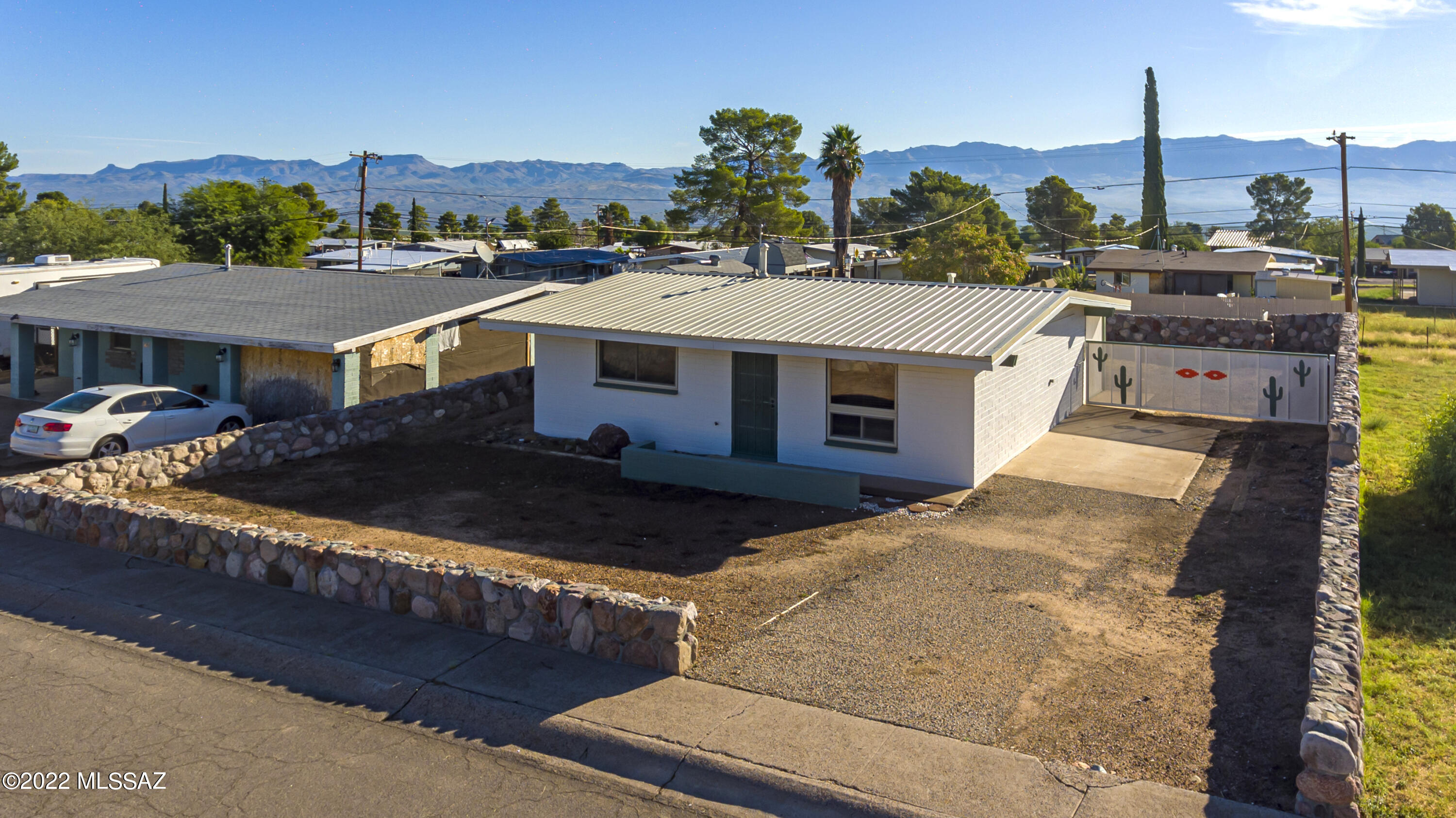 This adorable 2 bedroom 1 bath home is ready for you to move right on in.   The remodeled kitchen and bath are so inviting.  From the custom rock wall and custom gates make this backyard so welcoming with the most amazing mountain views.  Side gate fully opens up for full access to the backyard.  So much more potential beyond the rock wall.  Come see what this home has to offer - inside and out.