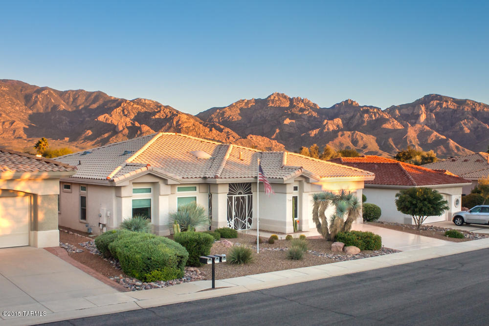 Sun City Oro Valley-Amazing updated Sunrise model w/Catalina Mountain views from premium lot backing to AZ state Trust land w/no home behind. Spectacular 2,097sf 2BR/2BA+den & 21/2 car garage. Newly remodeled Kitchen has new granite countertops, under mount sink & cherry cabinets w/ash white finish. Built-in computer desk. Family room off kitchen has fireplace. Newly remodeled master bath has granite shower, double vessel sinks, new Cherry cabinets, lights & mirror. Guest bath has new Quartz counter, mirror, light & stone shower & walk-in closet. New epoxy coated garage floor & driveway, all new Pella windows, 20'' tile thruout except carpeted LR. Covered patio has extended aluminum ramada w/remote sun screens. Screened entry has tile wall murals by local renowned artist.