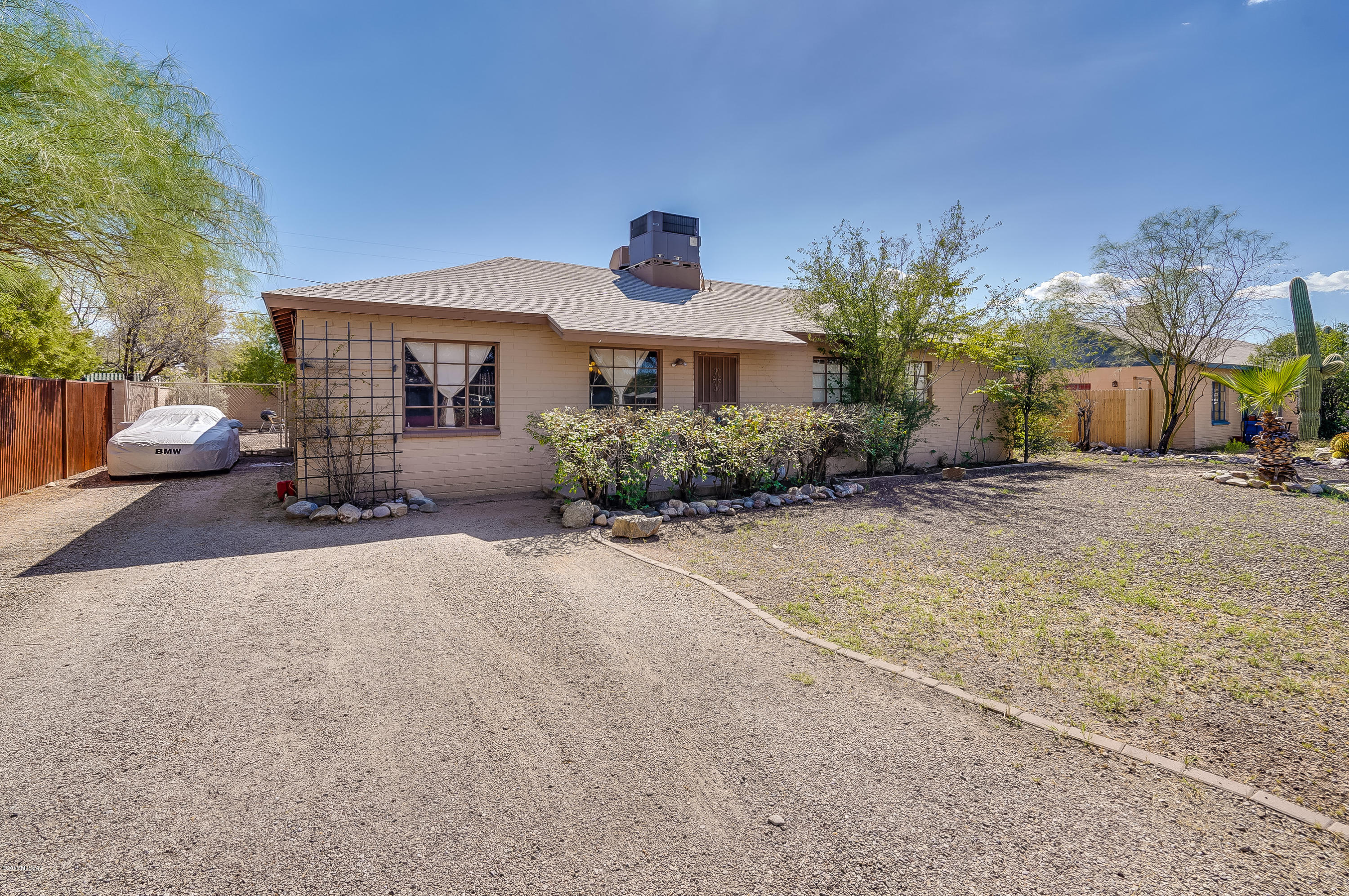 Fantastic Mid-Century 5 Bed/2 Bath home. That's right, 5 bedrooms! Plenty of room with over 2000 sq ft. Granite tile counters compliment the
wood ceilings in the kitchen. Stainless steel appliances, newer paint, tile in all the right places and a fireplace in the family room. Relax under
the covered patio after a dip in the wonderful pool! Large back yard for entertaining! Great Central Tucson location minutes from all
conveniences.