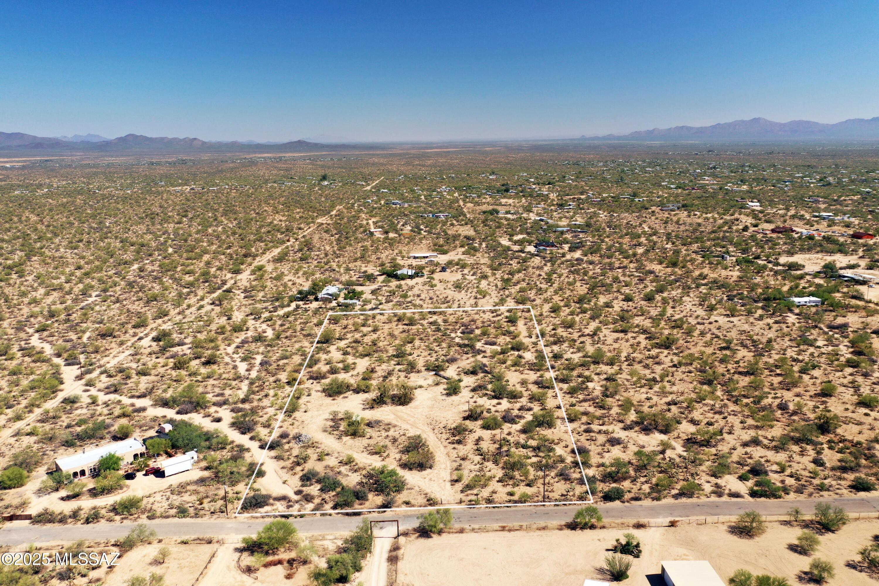 This peaceful 5-acre desert lot sounds like a fantastic opportunity! With essential utilities
 already in place, including a water meter, electric pole, and septic system, plus a letter from Pima County regarding an exemption to the impact fee, it's ready for development. The fully fenced and gated property, complete with a circular driveway leading to the old build site, offers stunning mountain views, perfect for enjoying sunrises, sunsets and the valley. Its location off a paved road adds convenience, making it easy to access nearby amenities like Ace Hardware, shopping, and dining. This serene piece of the Arizona desert could be an ideal spot for your custom or manufactured home. Don't miss out on this chance to own a slice of tranquility!