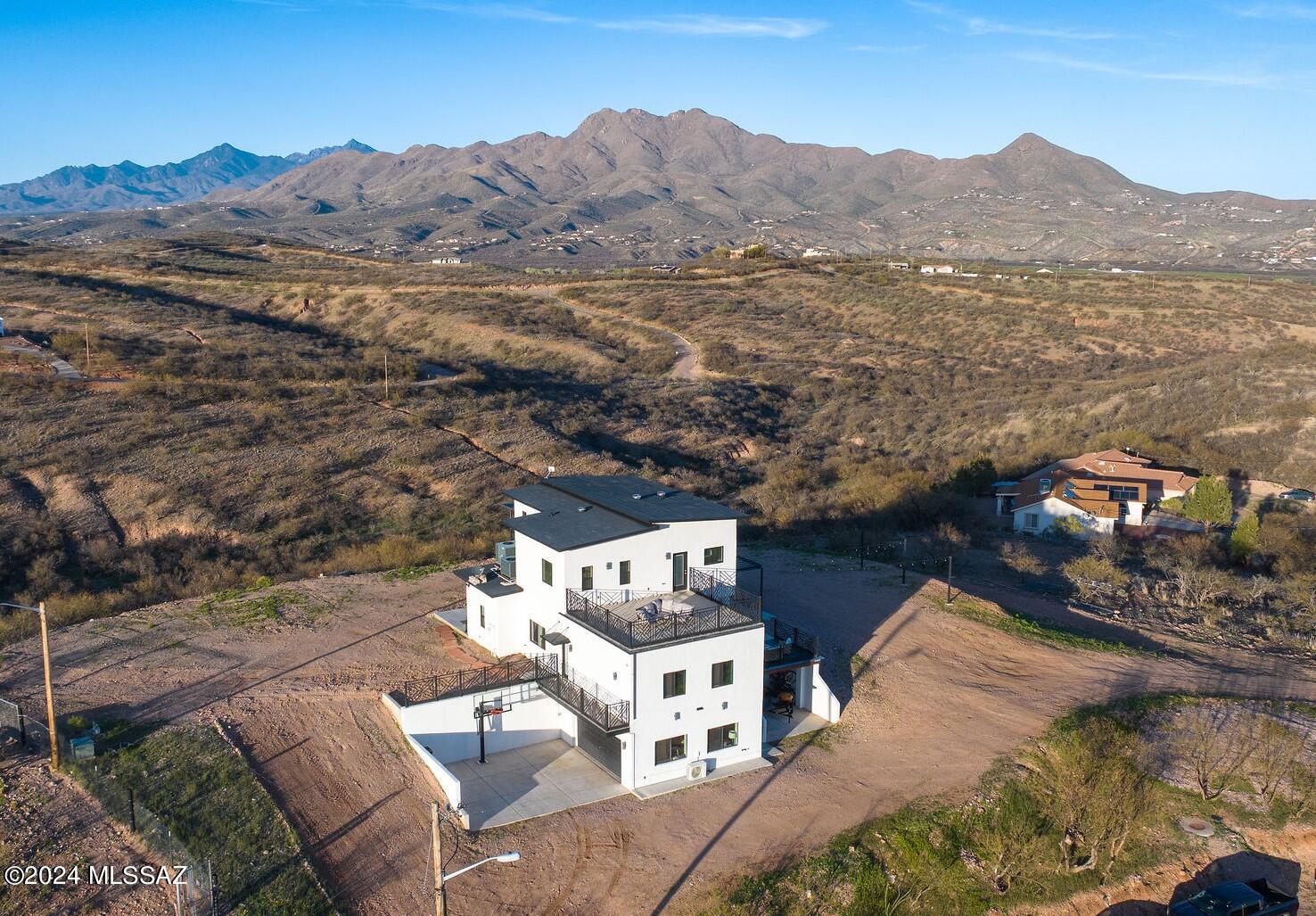 Welcome to this architectural masterpiece nestled atop a gentle hill, offering sweeping 360* vistas that will leave you breathless. This three story residence boasts a harmonious blend of sleek design, luxurious finishes and an abundance of natural light. This open-concept connects the living, dinning, and kitchen spaces. The chef's kitchen features a full gas stove, plus extra built in oven, a large center island and plenty of cabinet & quartz countertop space. The master suite is a sanctuary of tranquility, with a large hidden walk-in closet, and spa like bathroom. Multiple balconies, decks and patios provide the perfect spot for morning coffee, sunset cocktails or stargazing!