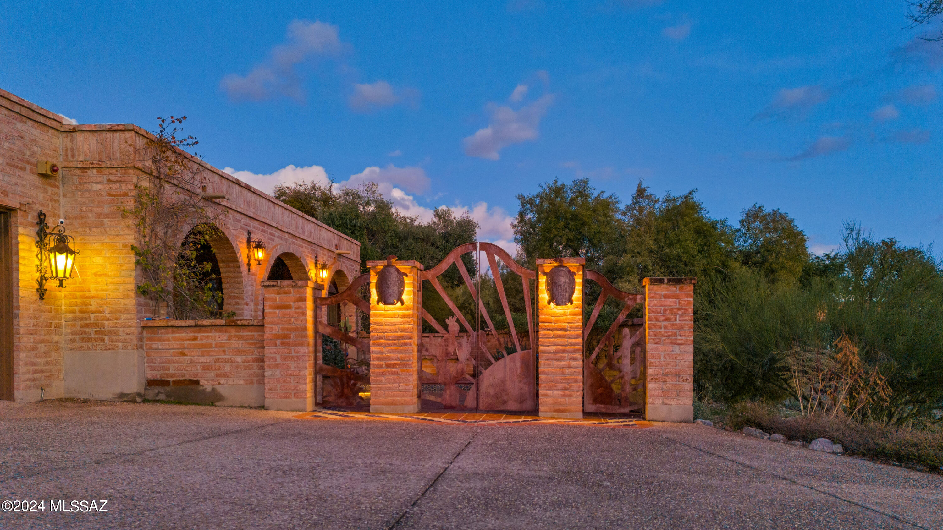Located in the highly sought-after Catalina Foothills Estates #9, this quintessential burnt-adobe territorial style residence on an elevated 1-acre lot delivers unobstructed, up-close mountain views to the north & twinkling city lights to south. Enjoy convenience without giving up the natural beauty of the desert & privacy.Very low price per square foot.  Exposed aggregate circular driveway & motorcourt with plenty of space for parking.  A handmade iron gate & burnt adobe walls enclose a charming courtyard with Mexican tile accents & a covered entry.  Spacious living room & formal dining room off of the entry. Kitchen w/ center island & breakfast nook w/ sliding glass door that leads to covered patio & outdoor kitchen area perfect for merging the indoor & outdoor living spaces while enjoying the marvelous views.