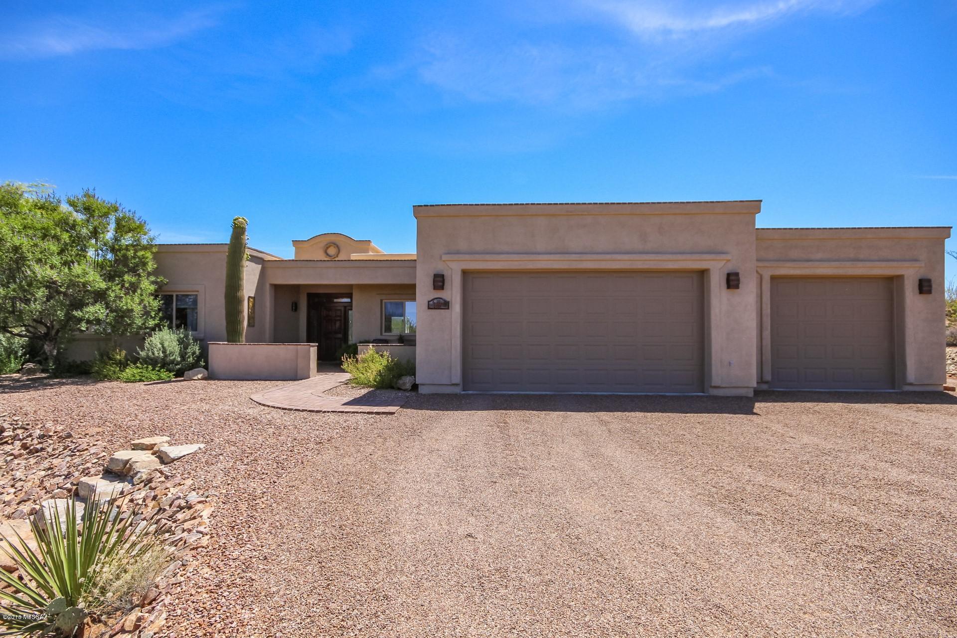 Seller will accept or counter offers in the range of $499,900-$515,000. STUNNING custom built home on almost 2 acres in Vail! Roof was recoated & home was freshly painted inside & out in 4/18. Brand new carpet & stained wood doors throughout. Home features an open concept kitchen complete w/ a plethora of custom walnut stained cabinets, built-in wine rack, wet bar, granite, SS appliances & center island. Family room has stacked stone fireplace- can be wood or gas. Master retreat has private exit to backyard. Full spa bathroom w/ his + her vanities & separate soaking tub + walk in shower. Spacious walk in closet! Resort style backyard boasts panoramic mtn & desert views, sparkling pool + spa, built-in BBQ, & fire pit. The perfect home for entertaining!