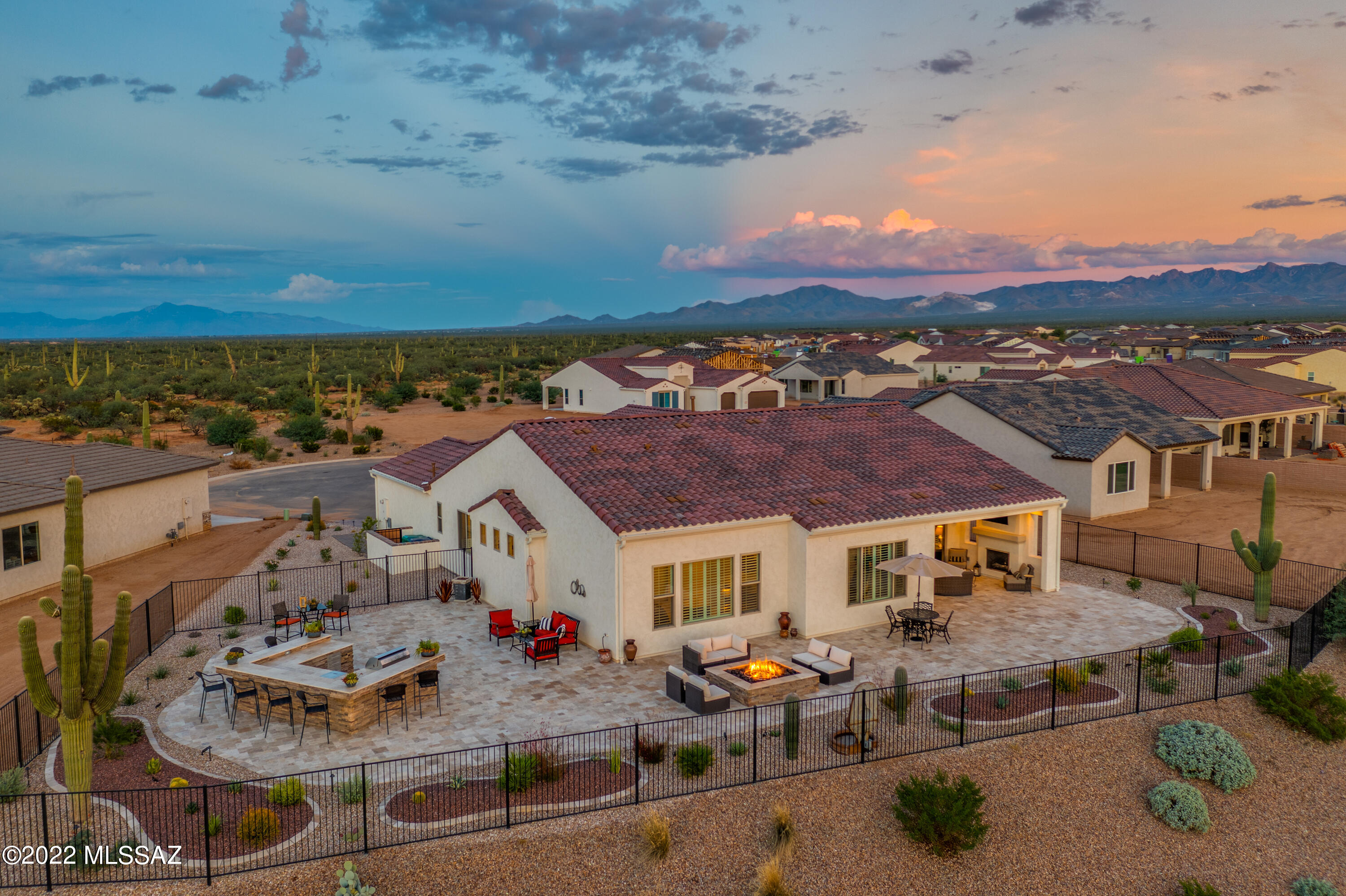 Exquisite ''Estate'' series LUXURY HOME in Quail Creek. Expanded Avalon w/ 2,937 sq.ft., 2 BR suites, 2.5 baths, Den AND Bonus office (opt .3rd BR). Loaded with TOP OF THE LINE finishes, this 2022 home has all the benefits of new construction without the wait, $235K in builder options + $160K in after-market upgrades and landscaping. EVERY DETAIL IS 1ST CLASS: iron entry gate and front door, crown molding throughout, all tile floors, upgraded cabinets, quartz counters, butlers pantry, wet bar, GE Cafe SS appliances, upgraded fans, lighting, plantation shutters. Spacious owners suite w/ walk-in spa shower. All travertine rear patios with gas fireplace, fire pit, outdoor kitchen, majestic saguaros, stunning views. 3 car garage w/ epoxy floor, cabinets, paver driveway. Upgrade list in docs.