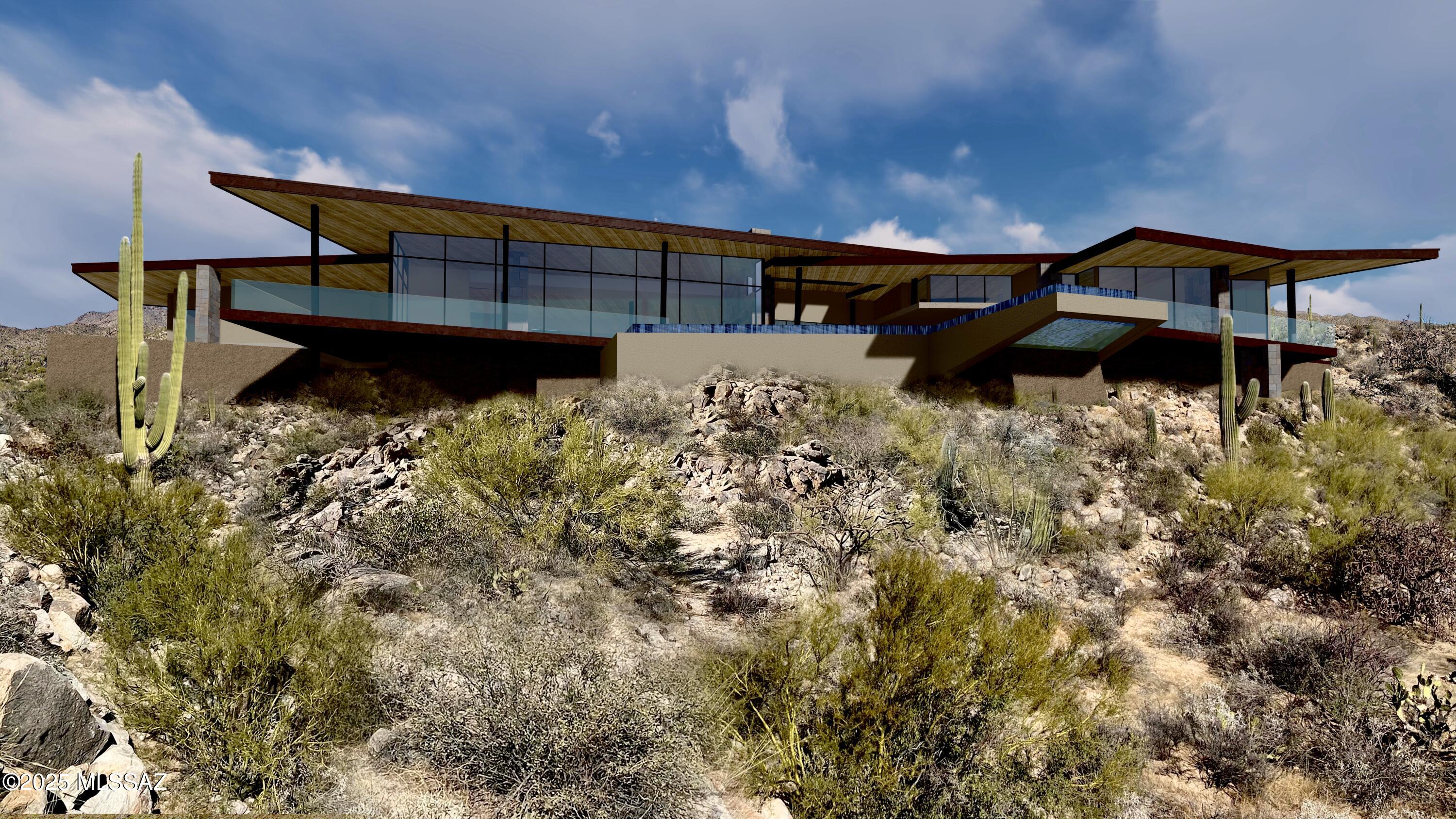 Immerse yourself in contemporary sophistication with this modern masterpiece crafted by renowned, award-winning architect Kevin Howard. Set within the tranquil beauty of Saguaro Ranch, this exceptional home showcases expansive floor-to-ceiling windows that frame panoramic views of the majestic Catalina Mountains—seamlessly merging modern design with the timeless allure of AZ's desert landscape.
Envision a residence that not only embodies architectural excellence but also evolves with your lifestyle. With Kevin Howard's celebrated expertise, every aspect of the design can be tailored to your unique preferences, creating a home that is both deeply personal & effortlessly functional.
Contact us today to schedule a private tour & explore the opportunity to meet with the architect, K. Howar