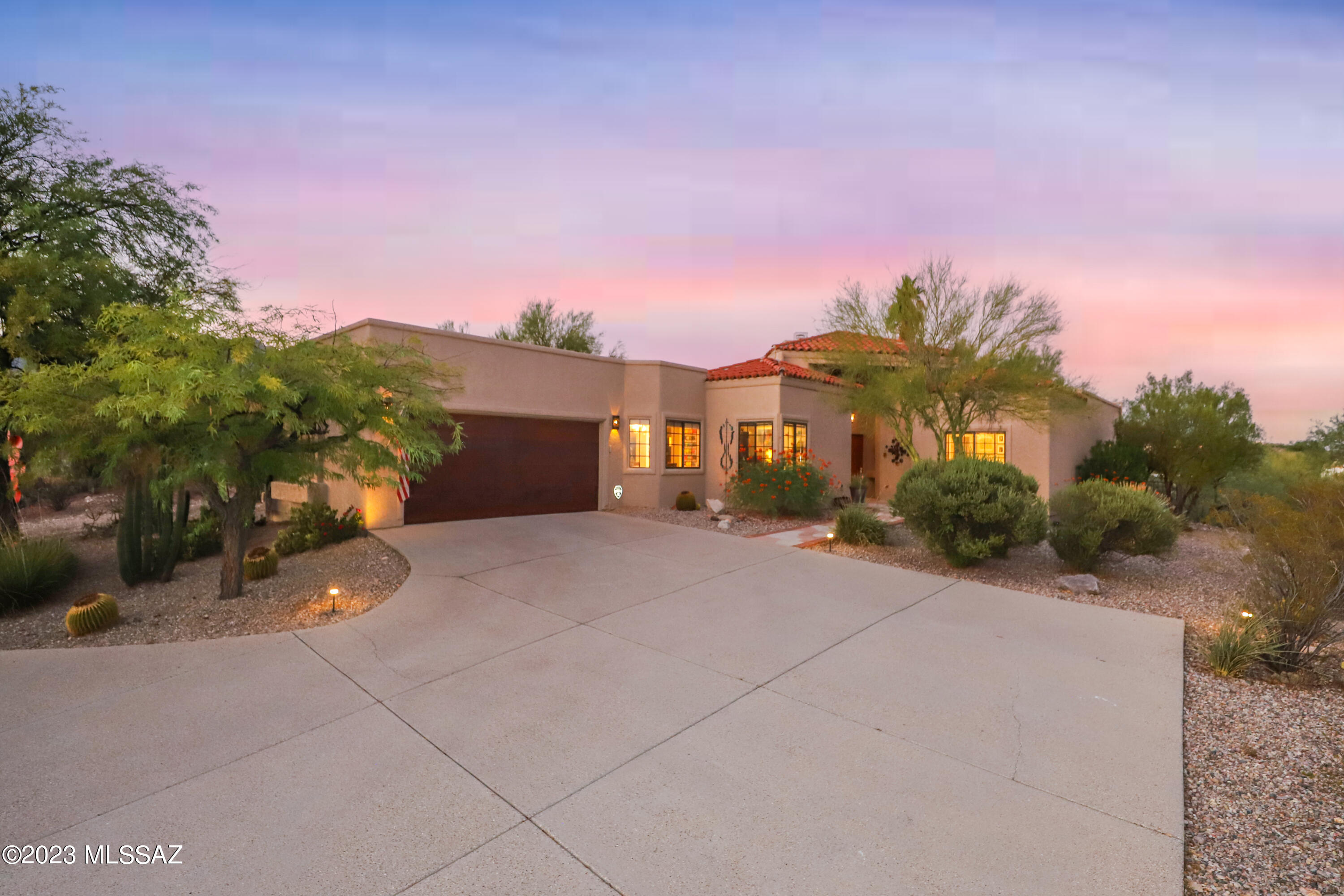 Mountain & City views from this custom SW contemporary home in the foothills of a quiet neighborhood. Drive up the circular driveway to this beautiful home with magical views of sunsets and sunrises.   Exceptional 15-foot ceilings in the living room with fireplace bordered by large windows to fill the room with natural light. 10-foot ceilings in the remainder of the home.  The kitchen was recently remodeled complete with  quartz countertop & marble tile backsplash, Ruvati sink, Kohler faucet, stainless steel gas stove and dishwasher. Simply beautiful! The adjoining family room has a large wet bar area with a new quartz countertop, sink & faucet. This home has a large tranquil primary bedroom with recently remodeled luxury bathroom featuring a glass shower with shower system including a rain showerhead, 22" soothing deep soaker tub and new quartz countertop. Access to the backyard from the family room, living room and primary bedroom. The custom designed refreshing plunge pool has a new heater, pump & filter, an elevated spa, water feature and nearby newly built outdoor shower. What a comfortable home for entertaining or relaxing in your own little paradise with panoramic views of all four mountain ranges and city lights. Close to shopping, Sabino Canyon, and Tucson Medical Center.