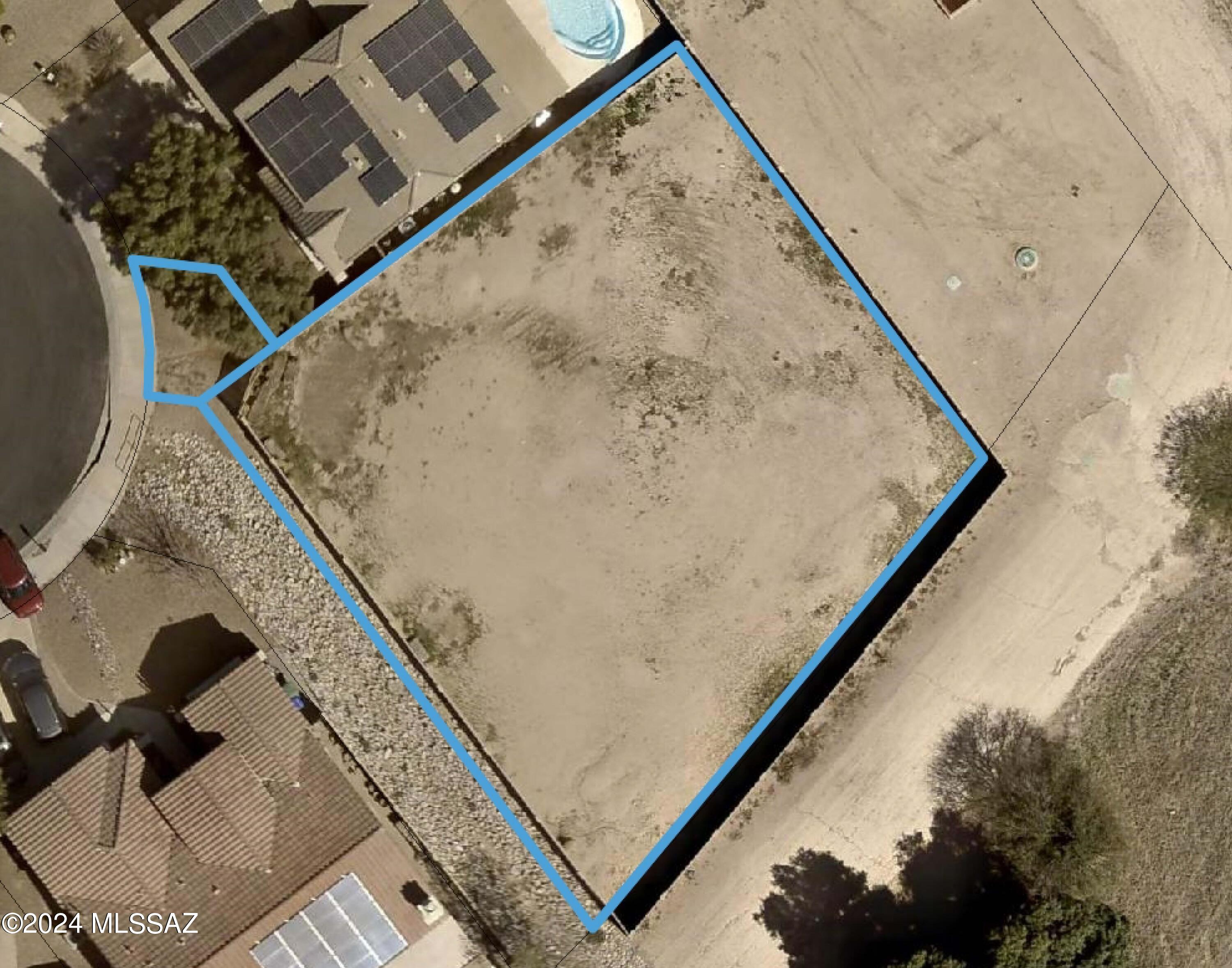 Exceptional opportunity for a builder/developer or purchaser to buy nearly a quarter acre of vacant land on a cul-de-sac, with only one direct neighbor in an existing subdivision. Utilities are all adjacent to property or in the road for easy connections. Existing masonry wall on all four sides offers maximum privacy. Access is through common area with dedicated easement (see documents). Views to the Catalinas, Tortolitas, and Sombrero Peak. Property backs up to Pima County's ''The Loop'' providing over a hundred of miles of paved shared use trails throughout the Tucson Area. Property is not currently in HOA but has potential to be annexed. CC&Rs attached in documents for HOA. Owner is a licensed real estate agent.