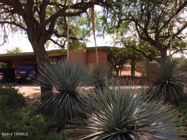 This mid-century historic Indian Ridge burnt adobe ranch home simply oozes charm! From the tip of the gorgeous tall wood beam ceilings, to the lovely front picture windows with privacy coating that look out onto pretty vegetation, to the cute and colorful kitchen with copper colored cabinet hardware. Incredible master bedroom suite with library/seating area. Wonderful natural light, mostly triple pane updated windows, fabulous custom cellular window shades that open from either top or bottom, beautiful wooden interior doors, and two sets of French doors lead out to the patio. Huge 0.41 acre corner lot features divided yards for whatever suits your purpose. Sparkling Pebble-Tec pool w/waterfall, huge raised garden, mature vegetation. Voluntary HOA is $25 per year! A most unique retreat!