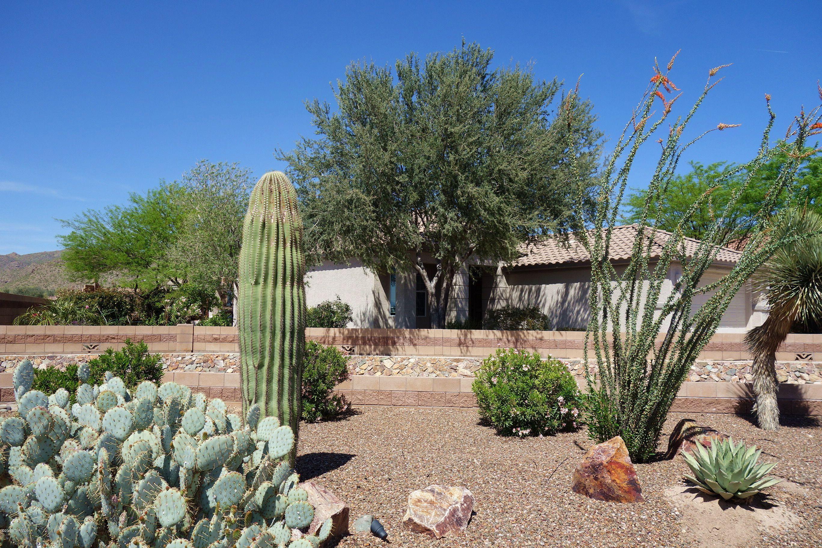 CHARMING HOME IN THE HIGHLANDS ON A LARGE PREMIUM LOT WITH AN ELEVATED SEATING AREA TO ENJOY BEAUTIFUL SUNSET VIEWS!! Gated 50+ Active Adult Community- Golf/Tennis- Clubhouse-Pool-Spa- Numerous upgrades- 20 x 20'' custom tile with laminate wood flooring- Extended laundry/office area with extra cabinets and built-in desk- French doors in kitchen area- Bronze hardware-Inside of home recently painted with custom colors- Newer energy efficient AC unit- Jetted tub in master bath- Additional shelving. Built-in gas BBQ on pavered back patio! Luscious citrus trees on the side of the home and large shade tree in back yard to enjoy outside kitchen area and raised deck!  Home is also located in a small cul-de-sac like situation off of Winding Desert Drive. Pride of ownership shines in this home!! The Highlands at Dove Mountain- Active Adult  50+ Golf and Tennis Community- Arthur Hills designed championship golf course- Clubhouse offers tennis, pickleball, ballroom, restaurant, library, card and craft rooms, billiard room and a host of clubs. Enjoy The Highlands lifestyle!