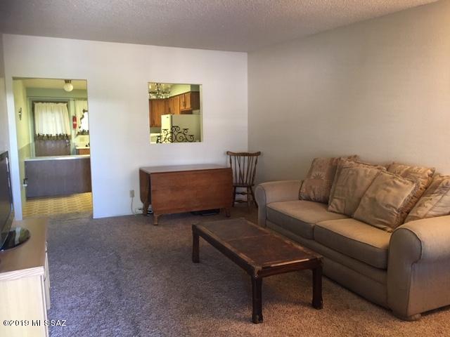 WON'T LAST LONG-  Centrally located 2 bedroom and 2 bath brick townhouse.  Tucked into a small and well established community. It's in good condition and move-in ready.  The home features new vanities, nice covered patio, small backyard, seperate laundry room off the back patio.  Quick access to the University of Arizona, transportation, shopping and restaurants.  (drapes do not convey) (washer/dryer convey AS-IS)