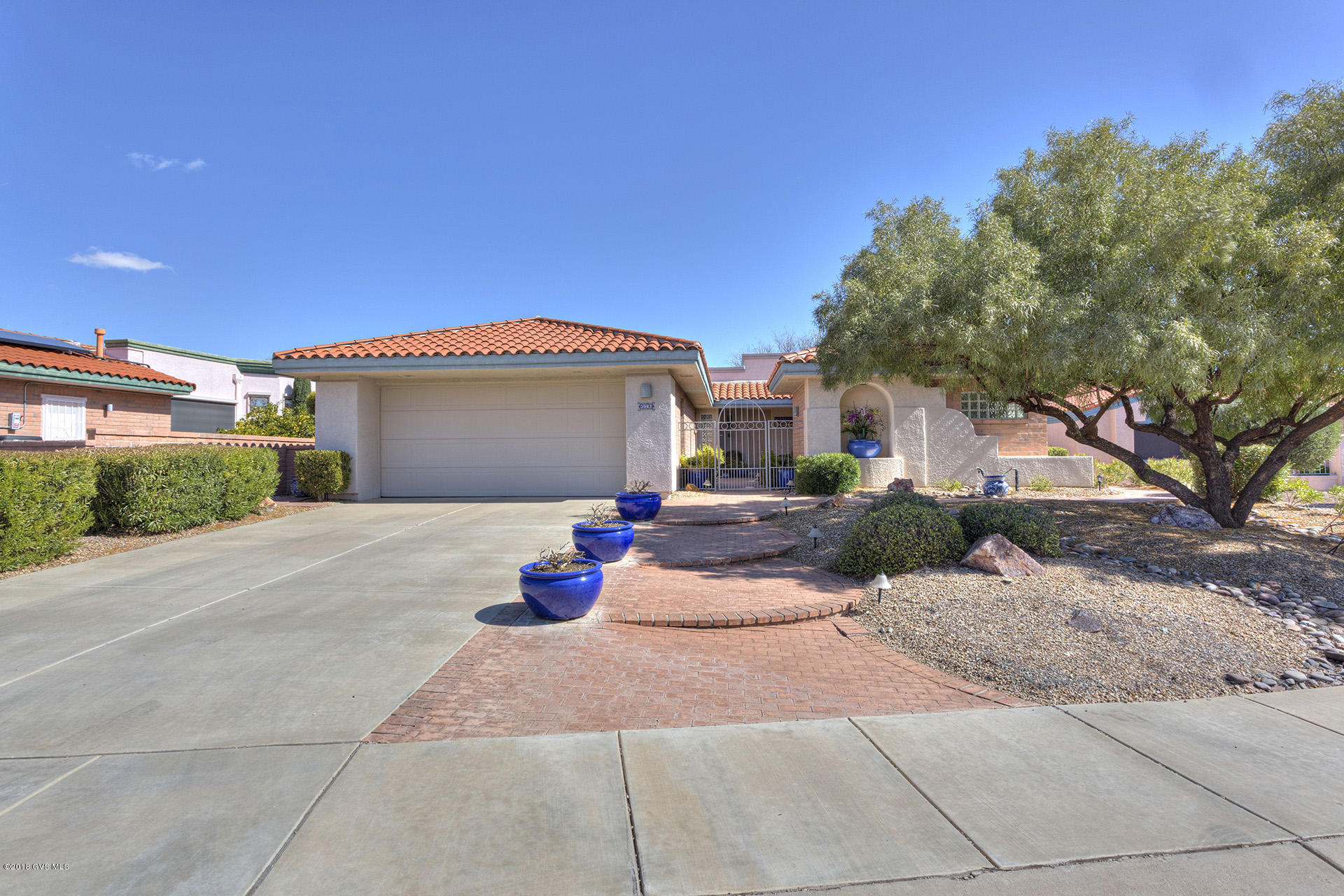Enter into this lovely home with a wall of windows looking out over the pool, 14th hole of San Ignacio Golf Course and panoramic view of the valley and Santa Rita mountains! Great dining room with plenty of windows with amazing views and a beautiful large glass shelf. Large kitchen with center island with cook-top, double ovens, ample counter space, and bar with bar stools. Very large den/eat-in kitchen with wet bar with refrigerator and spectacular view of mountains! Split floor plan w den/office off master with patio access. Nice sized master bedroom with plantation shutters, 5 piece bath with snail shower, huge walk-in closet with built-ins. Large 2nd bedroom with large full bath. Glorious backyard with 2 brick covered patios, swimming pool artificial grass and spectacular views  of golf course and Santa Rita mountains! This house is in pristine condition with one of a kind views! Won't last long - Call for showing 520-340-0077.