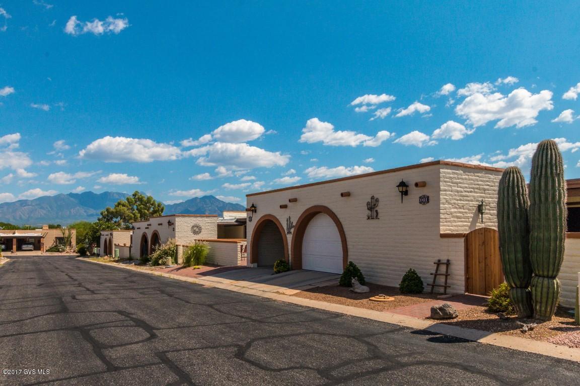 Your desert hideaway awaits! As you approach the property you will appreciate the breathtaking backdrop of the Santa Rita Mountains. The front courtyard is an entertainer's delight, fully equipped with an outdoor sink, dining area, and custom stone work. A fully enclosed garage houses a separate golf cart garage or workspace for projects. Inside you will find light pouring in through multiple skylights and abundant windows. The light ceramic tile throughout adds to the bright open feel of this home. Retreat to your large master suite with abundant storage and access to the courtyard. A roomy guest room sits just off of the spacious kitchen and a laundry closet is conveniently located in the hallway just off the master suite. Don't let this immaculate oasis slip away. Welcome home!