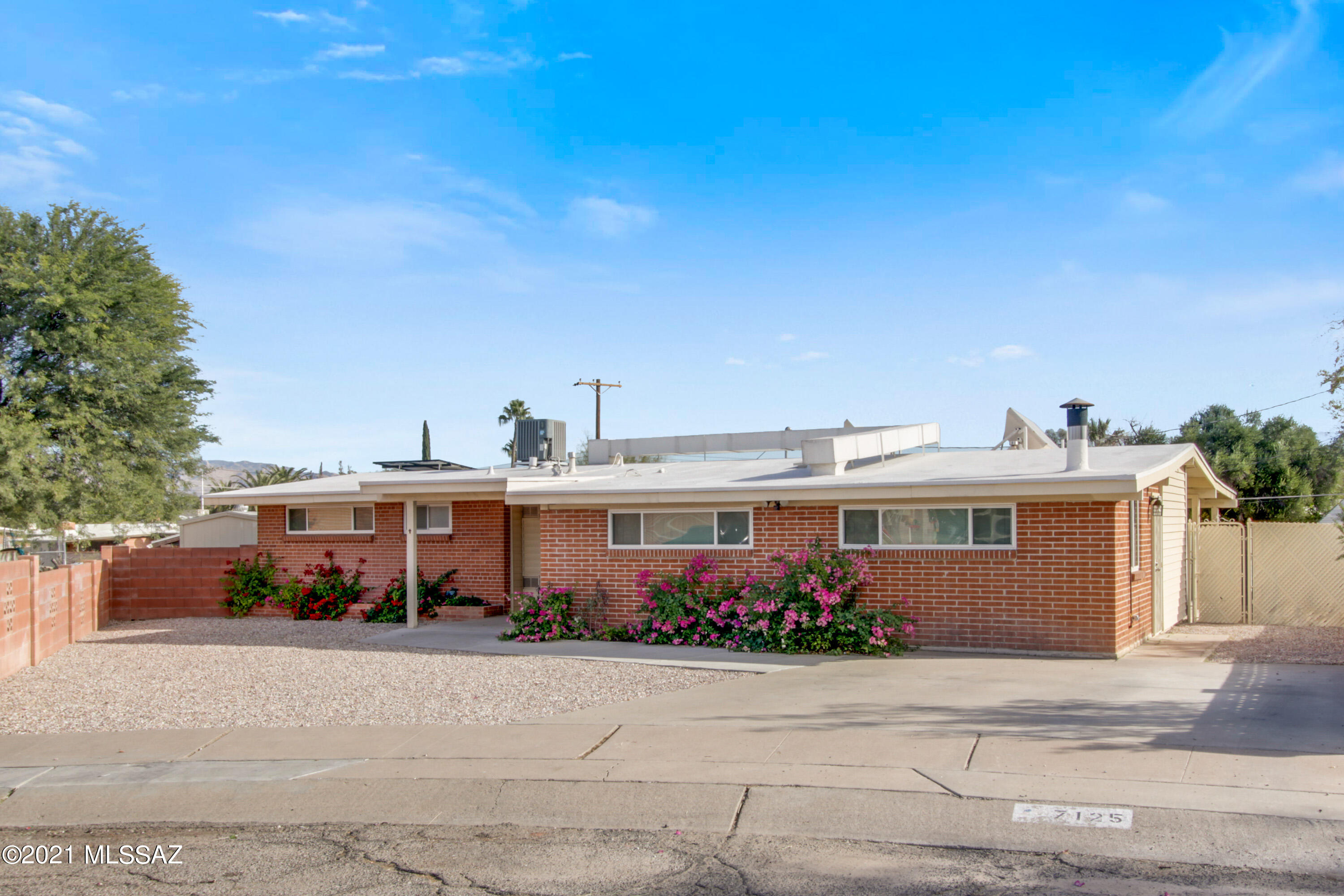 Range price: $325,000-335,000. Enjoy this well-maintained 2002 SF masonry home on a cul-de-sac on Tucson's Eastside, featuring 3 bedrooms, 2 remodeled bathrooms, an additional living room, an updated kitchen with granite countertops and stainless-steel appliances, and an extended flex/dining area with a ventless propane fireplace. One bedroom includes bonus room/office space with an exterior door. New LVP floors (no carpet), fresh paint, new light fixtures, dual pane windows, electrical panel 200 amp service, 2015 410A HVAC system, 2017 water heater, and a very low $53/mo solar lease that covers most or all of the electrical needs. Detached oversized one car garage/workshop with electric and alley access and a separate utility shed. Come. See. Stay!