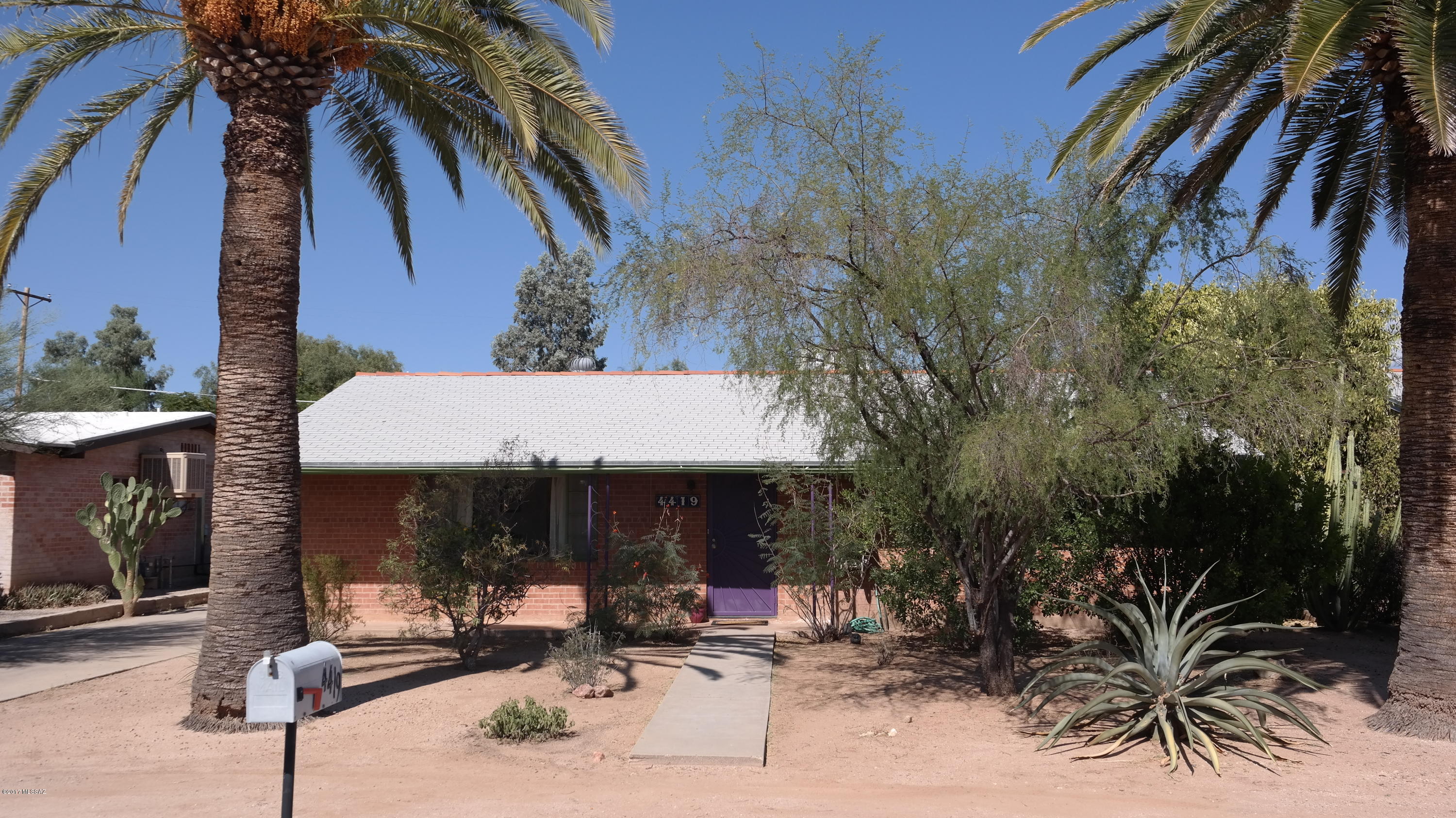 Enter this wonderfully maintained mid-century home centrally located in Poet's Square in the heart of Tucson. the updates throughout the home do not detract from the character of this comfortable layout. A combination of tile and wood laminate flooring create a warm feel along with new carpet in two of the bedrooms. Mechanicals are newer and have been serviced regularly. Entertain from the enclosed patio, out to the large backyard that holds two sheds, a covered carport and numerous fruit trees. All appliances are included. Close to shopping, UofA and Downtown, this property will sell quickly, so call for your private showing today!