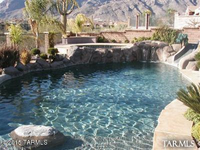 STUNNING 4BDR/3.5BA IN CATALINA FOOTHILLS WITH AMAZING VIEWS. ENJOY YOUR OWN TUCSON RESORT W/FABULOUS SPARKLING POOL & SPA, WATERFALL,PUTTING GREEN & EXTENDED COVERED PATIO! GORGEOUS 18IN. TRAVERTINE FLRS,BEAUTIFUL WINDOW COVERINGS, DESIGNER COLORS, EXQUISTIE FIXTURES-FABULOUS,TASTEFUL UPGRADES. MASTER SUITE ON MAIN FLOOR OFFERS TWO SPACIOUS WALK-IN CLOSETS, LUXURY BATH AND SITTING
AREA. THREE SPACIOUS BDRMS/2 BATHS UPSTAIRS-1 BDRM IS A SUITE-LOFT,TOO! LGE FORMAL DINING-LIBRARY W/WALLS OF CHERRY BOOKCASES AND BUILT-IN WINE RACK. GOURMET STYLE KITCHEN W/FORMAL DINING ROOM, GREATROOM W/FIREPLACE, DEN/OFFICE AND MORE...ALL INSIDE A GATED FOOTHILLS COMMUNITY!