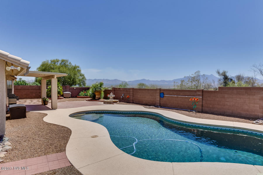 You'll love this home with DEAD-ON Mountain Views, NO rear neighbors, and a sparkling pool; located in a court on a premium lot. Enter inside and immediately you'll notice the plantation shutters and saltillo tile that flows throughout the living areas. Great room concept. Entertaining is a breeze in the spacious dining area and upgraded kitchen with hickory cabinets, granite counters and stainless appliances including a super-sized fridge/freezer. Double doors lead you into the grand Master Suite w/wood floors and a big walk-in closet. Master Bath features separate soaking tub, tiled walk-in shower & dual sink vanity. Split bedroom floor plan offers 2 more roomy bedrooms and hall bathroom. Relax under the covered patio in your backyard oasis, while taking in the panoramic mountain views