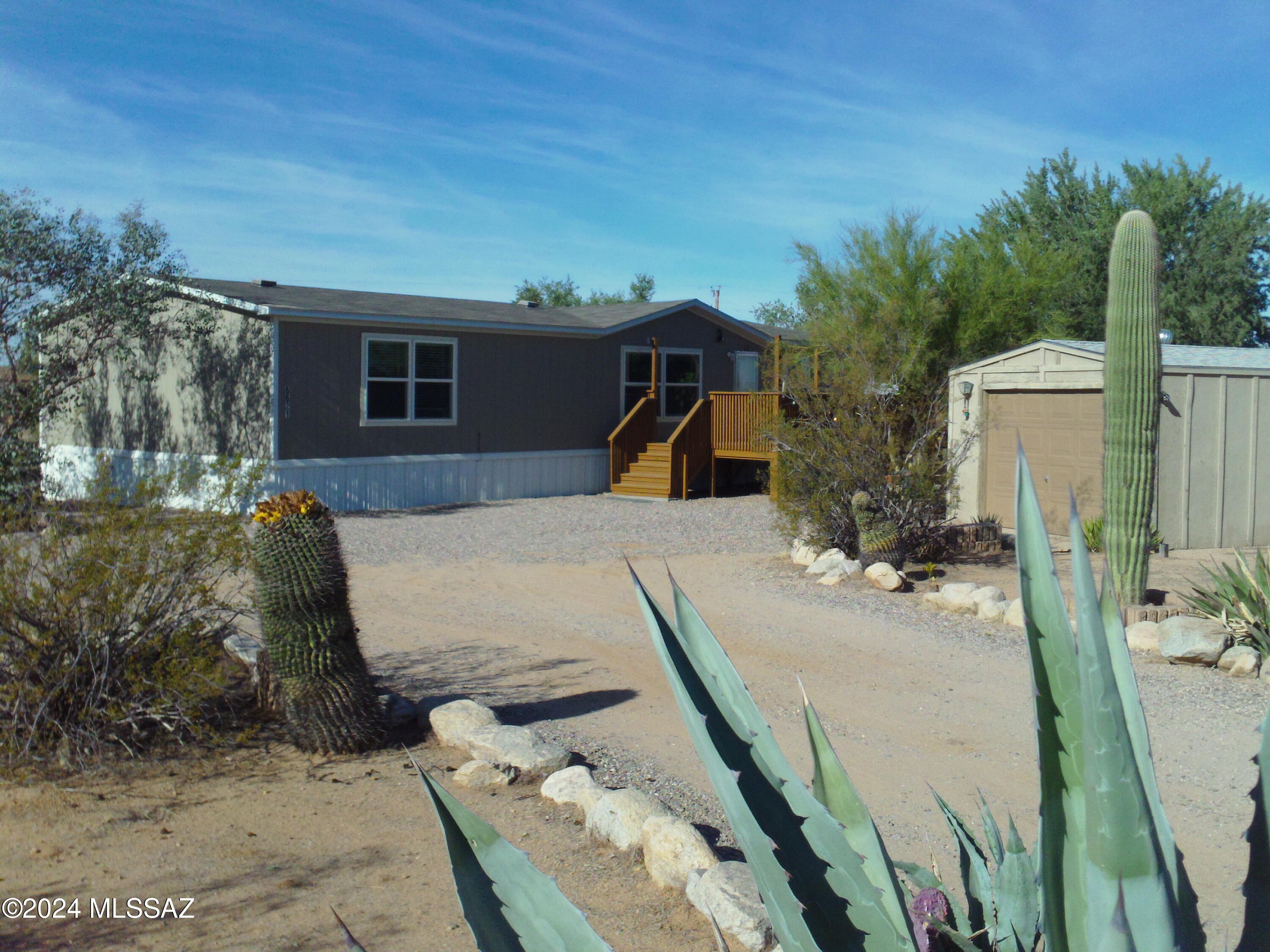 Welcome to your newer 2018 home in downtown Picture Rocks! Move-in ready 3 bedrooms 2 baths, w/detached 1.5 car garage with new garage roof in 2023 on a private fenced acre! Only 1 owner ever lived here! Recently painted 20ft X 12ft front deck! Brand New Carpet Jan '25! 2 Refrigerators convey-''as-is''! Newer washer & dryer included! Fenced area for your animals, 4H projects, or pets! No HOA! Newer home can qualify FHA or VA. Very Affordable, Clean, & Move-in Ready! Own your Own piece of Arizona today! Trustee/owner--please disclose. Offer~today