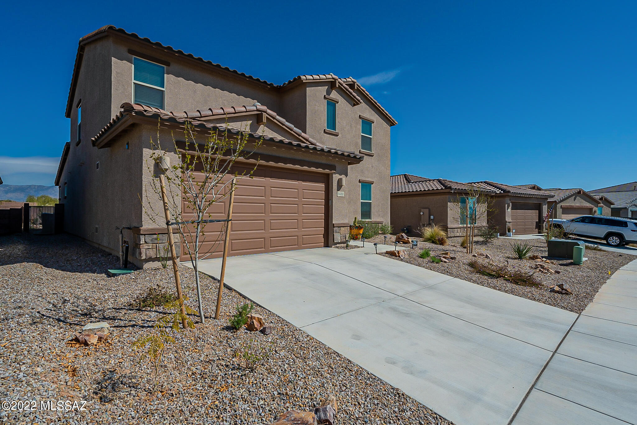 2020 Energy-efficient Smart Home, sweeping Sunrise Mountain Views. Boasting 4 spacious Bedrooms, 2.5 baths, downstairs Office/Den & Gourmet Kitchen, Open Floor Plan into Dining & Family Rooms. Kitchen & Owners Bath has Granite Countertops & tons of Storage. Second story offers a large loft. Ceiling Fans throughout, Garage Storage, Whole-House Water Filtration/Softener. Laundry Room includes Utility Sink w/storage Cabinet. Backyard includes edible oasis with fruit trees, vegetable & butterfly gardens, 4 zone irrigation controllable w/smart phone, Pergola with Retractable Awning. Neighborhood surrounded by Natural Protective Easement and trails leading to Ironwood Elementary. Community playground overlooks incredible views of the Catalinas, close to many Conveniences.