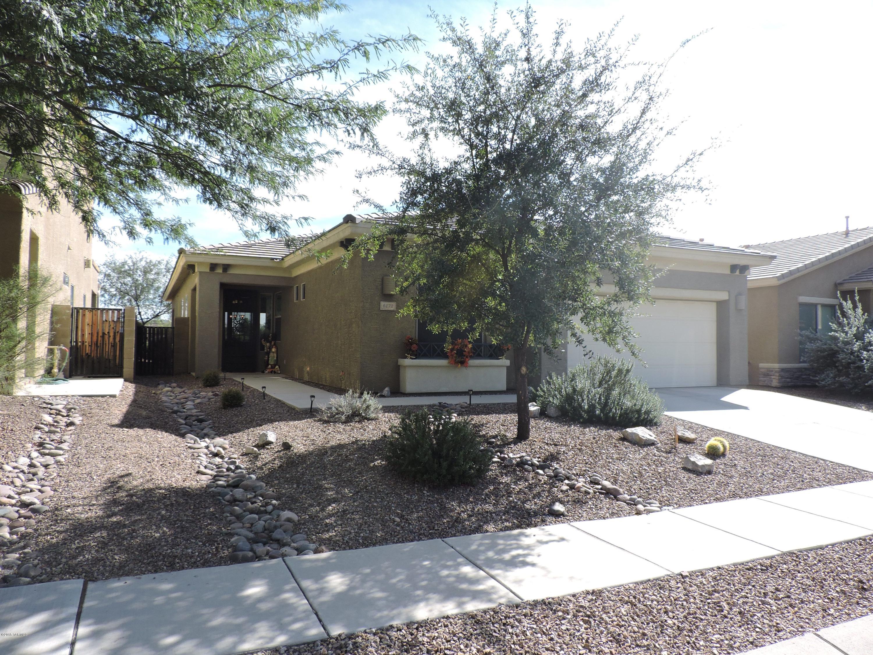 OPEN HOUSE SUN 2/28 1-4! Welcome to this immaculately clean, move-in ready home tucked away in a quaint NorthWest neighbourhood. Open concept floor plan welcomes you when you come through an attractive screened front door. Modern kitchen with plenty cabinets and good size pantry with gas stove is designed for your culinary needs. The split bedroom plan allows great space for guests as well as privacy. Three car tandem garage with built in cabinets is great for storage. East faced outside patio and low care yard allows you to enjoy Catalina and Santa Rita mountain ranges. Great views, awesome location and well taken care of home - what a great combination! A must see - call for an easy showing!