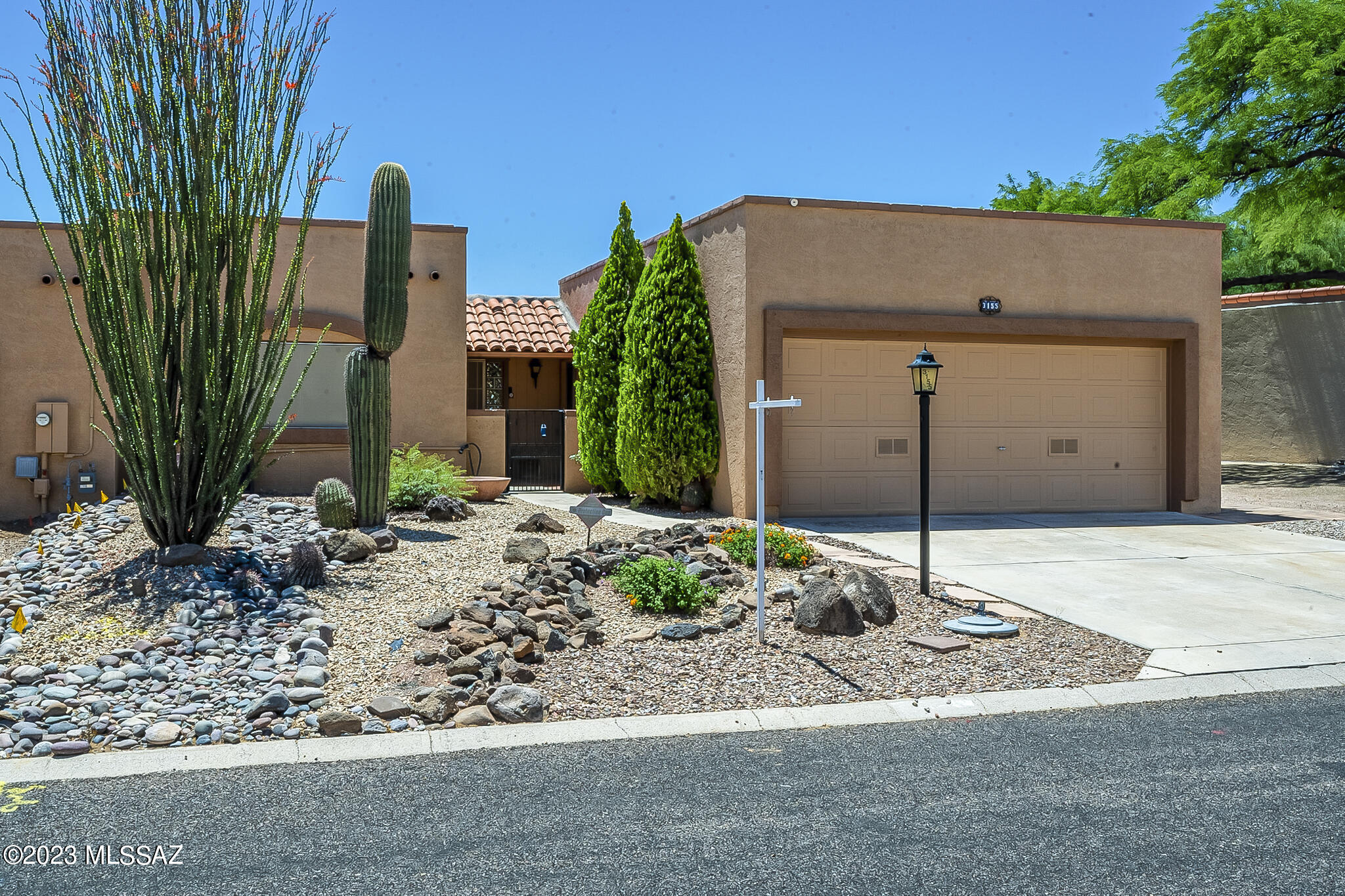 This is the home you've been waiting for! Absolutely spectacular mountain and desert views that span for miles and miles. Situated in the quiet community of Desert Hills 3, this home has been beautifully prepared for you. Spacious floorplan includes a living room and dining area where you can take in those fabulous views. The 75'' TV and sound system with speakers are included! Beautiful kitchen that is stocked with dishes and cookware and  has everything you need. Large primary bedroom with built in drawers, shelves and desk unit PLUS a walk-in closet; primary bathroom with step-in shower. The 2nd bedroom has a Murphy bed and great built-ins and closet. 2nd bathroom with a tub and shower. Enter the backyard and you'll be amazed by the clear panoramic views of the Mountains! Covered wrap around patio with misting system, sun shades, , fountains, ceiling fans, comfy patio furnishings, a top-of-the-line BBQ grill and an additional raised patio that is perfect for those moments when the mountains turn pink! Extended 2 car garage with utility sink, refrigerator and additional golf cart sized bay that is currently set up as a workshop, but could be used to park a golf cart. Front loading washer and dryer, all kitchen appliances and most furnishings stay! The mature trees and desert cactus add to the beauty of true Arizona living. GVR gives you access to 13 community centers and tons of activities. Close to shopping, I-19 access, medical offices and more. This home is definitely a gem...don't miss your chance to make it your home!