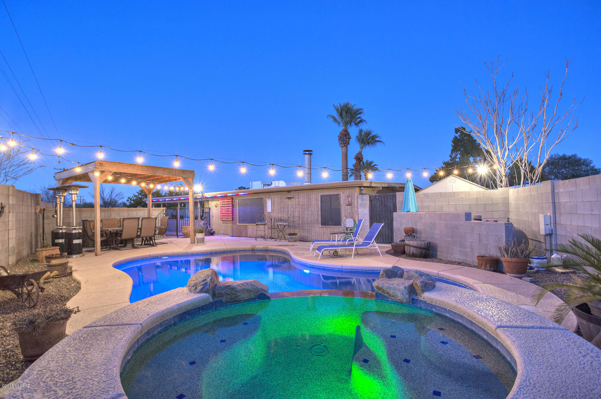 An Entertainers Dream! Welcome to your future pool home on a large lot in Santo Tomas Del Norte. This well maintained home boasts 4 bedrooms, two bathrooms, a large family room with fireplace and an open kitchen with updated cabinets, custom backsplash and all appliances. Tasteful 18 inch tile is found throughout the home. Large laundry room with washer, dryer and tons of storage space. There's plenty of room to entertain all of your family and friends in the private backyard that features a sparkling pool and spa, an oversized covered patio and a ramada. No rear neighbors! Double gate provides easy access to the backyard. Easy care front yard with a mature palm tree and luscious green grass in the Spring . What's not to love? This home has it all! Ask your Realtor for list of upgrades.