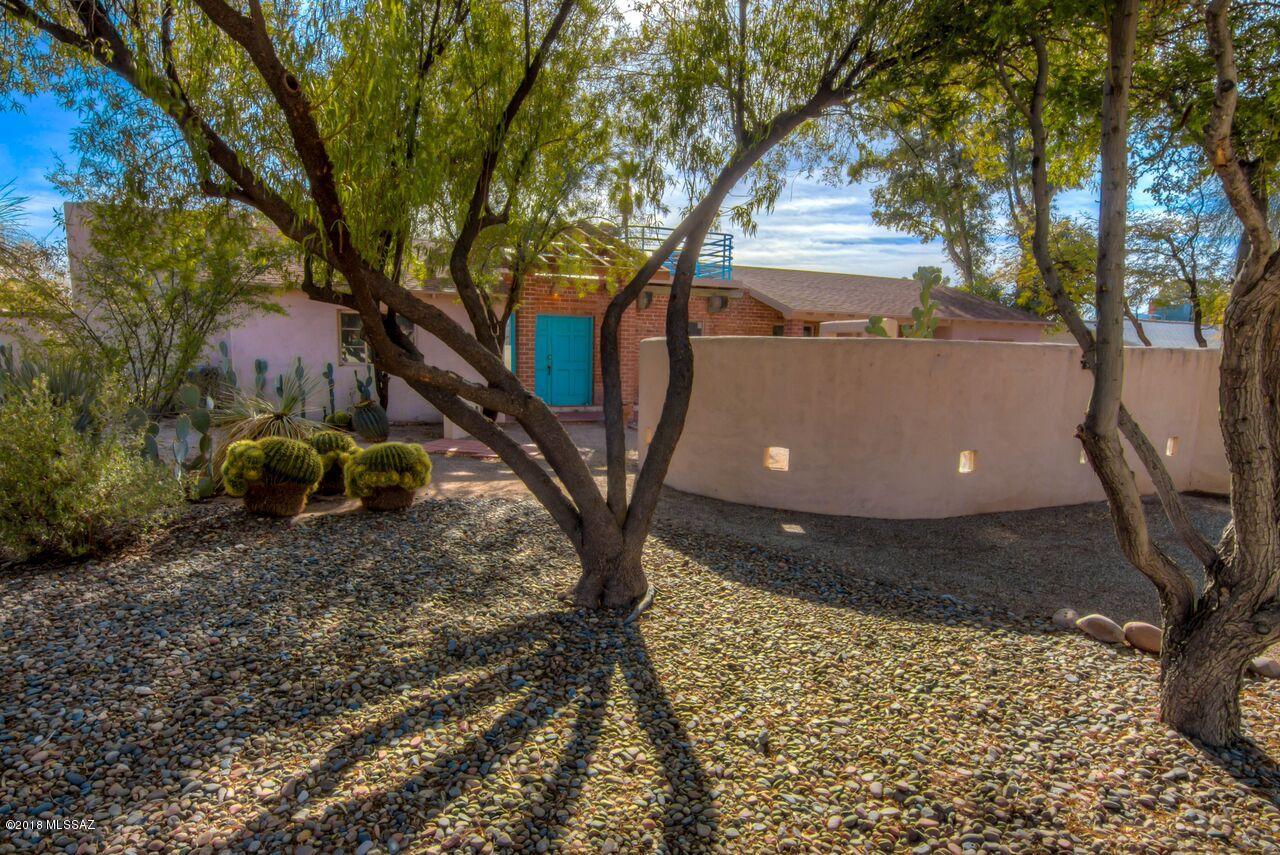 Seller will accept or counter offers between 300K and 315K.  Come and see this unique, one-of-a-kind historic San Clemente home at a good price! Remodeled in 1992 by well-known John Wesley Miller. This home has two wings separated by outdoor living room with fireplace and entertainment deck
above. Enormous corner lot with huge back yard set up with Aquaponics features and koi pond that conveys with the purchase. Double gate access to huge back yard for all your toys, space for RV. Low care yards, zoned heating and cooling, lots of storage including a shed.  Updated kitchen and light and bright floorplan. Near Reid park tennis, golf, bike trail, rec facilities. Easy access to UofA/downtown. Hurry!